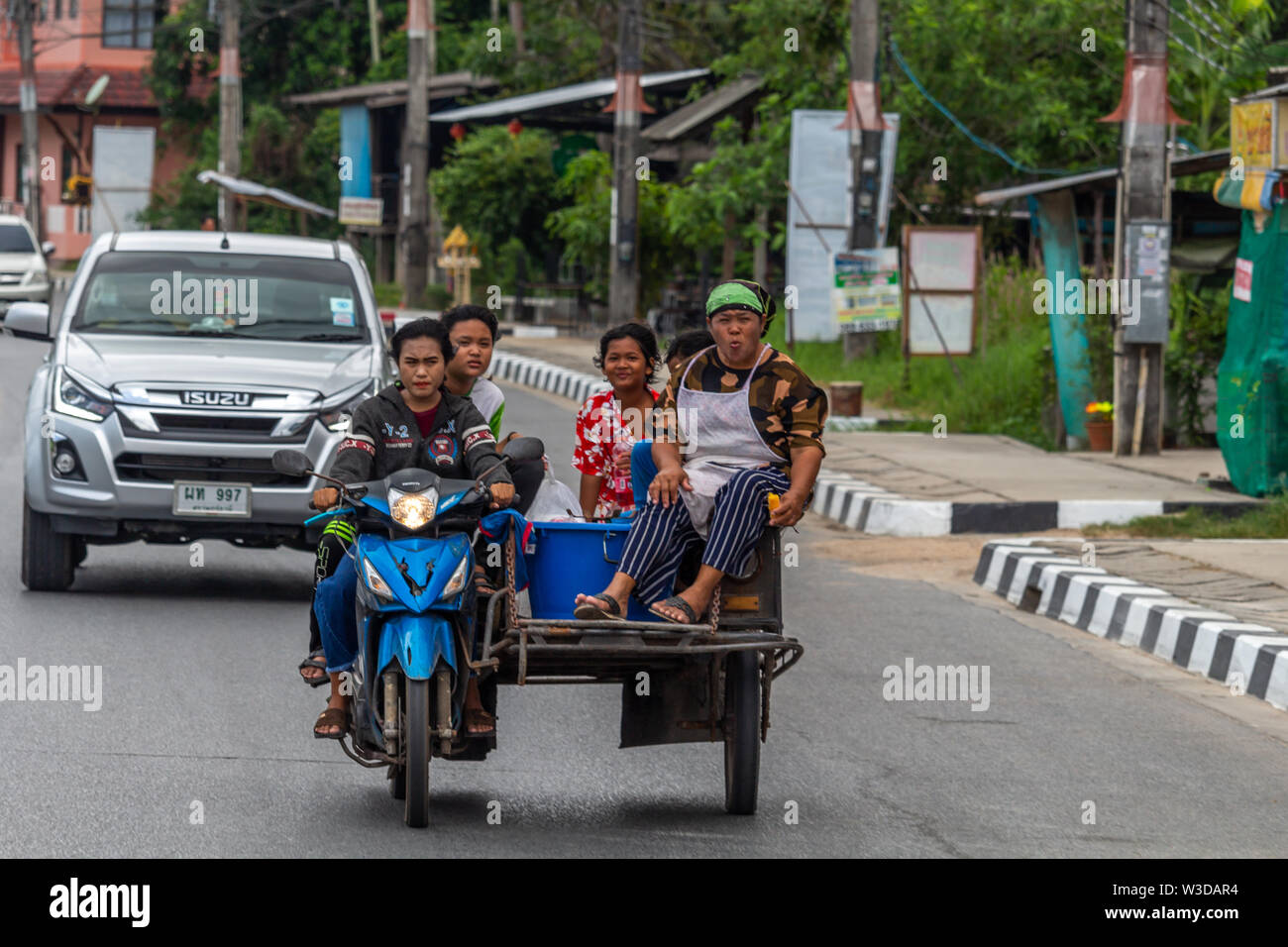Koh Samui, Thailand - April 16, 2019: Five women on a sidecar on the streets of Samui island Stock Photo