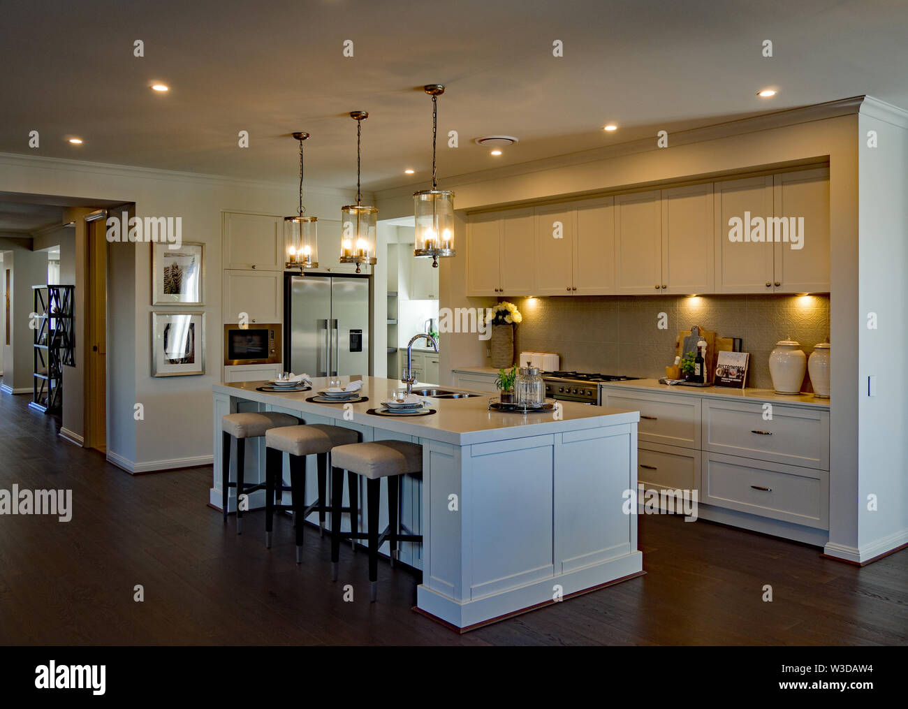 Large luxurious kitchen with ambient lighting and wooden floor Stock