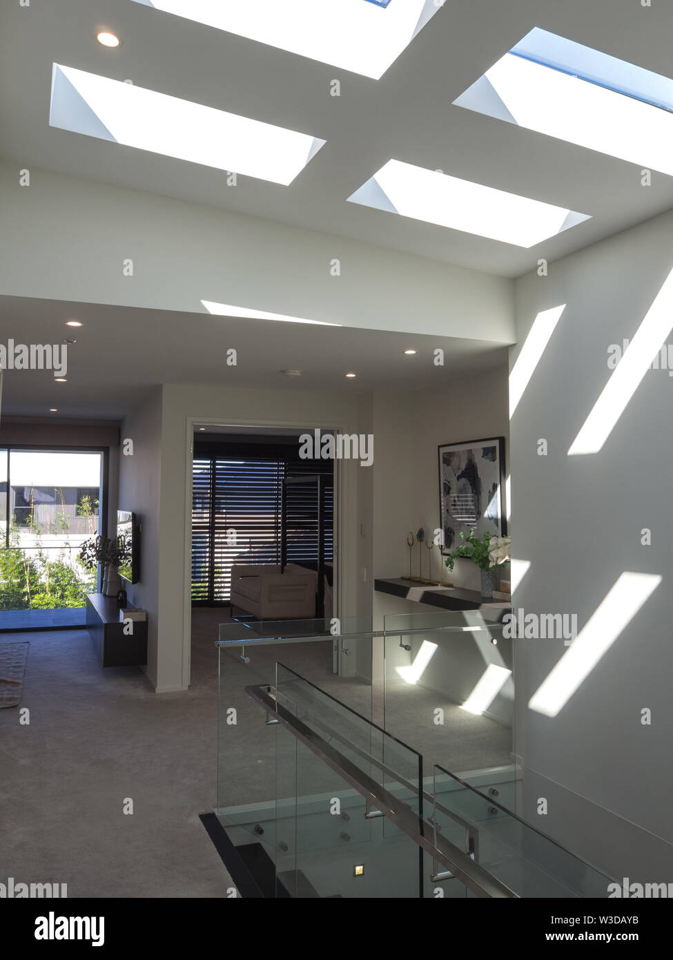 Modern Staircase With Bright Sunlight Through High Ceiling Windows