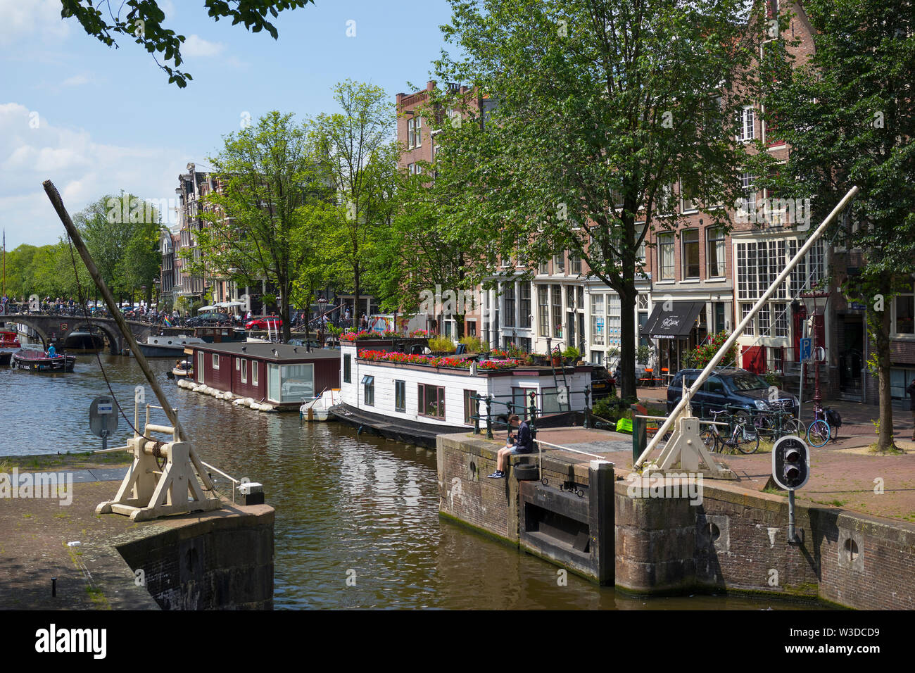 Amsterdam, Holland - June 22, 2019:  Boat lock on the Korte Prinsengracht and houseboat with flowers Stock Photo
