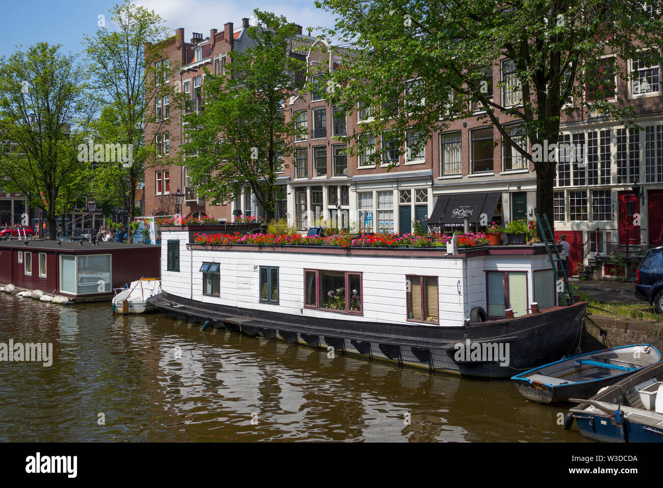 Amsterdam, Holland - June 22, 2019: Houseboat with flowers on the canal at the Korte Prinsengracht Stock Photo