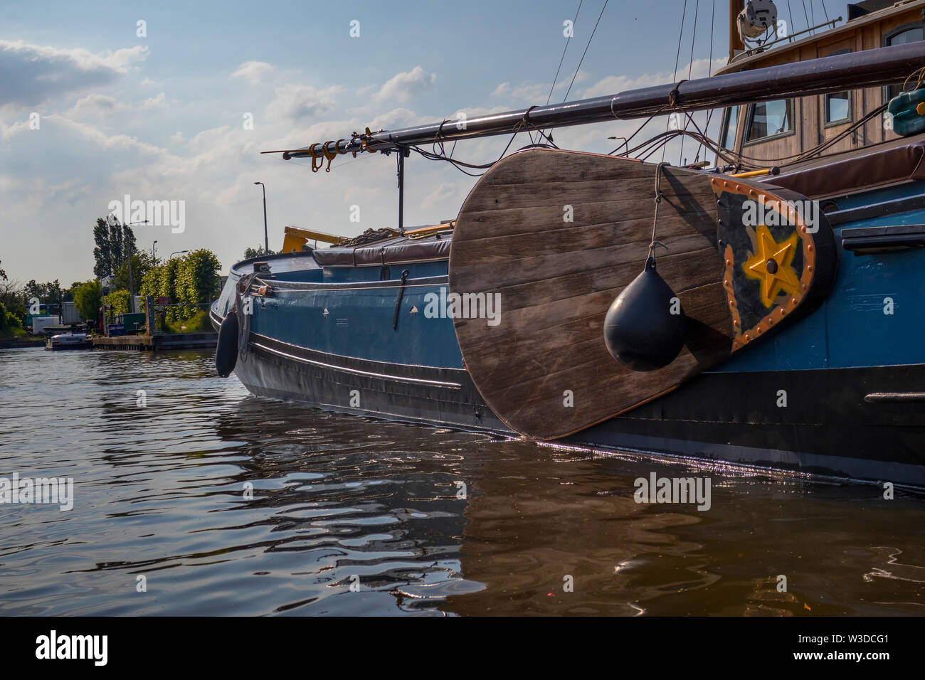 Amsterdam, Holland - June 22, 2019: Wooden Leebord of a historical sailboat in the canal Stock Photo