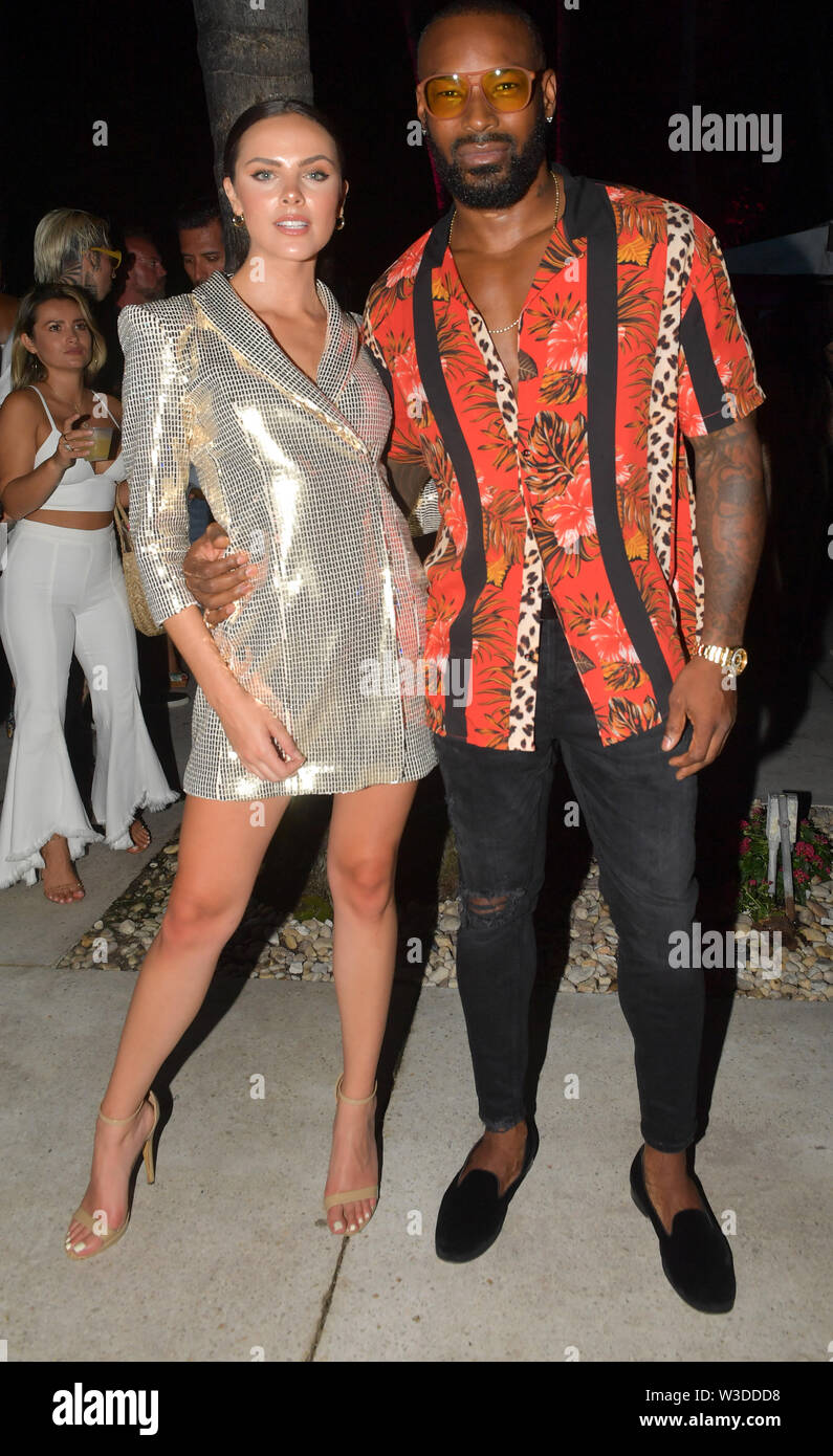 Miami Beach, Florida, USA. 14th July 2019. Model top influencer and brand  maker Olivia Caputo with Ralph Lauren supermodel Tyson Beckford attend the  2019 Sports Illustrated Swimsuit Runway Show During Miami Swim