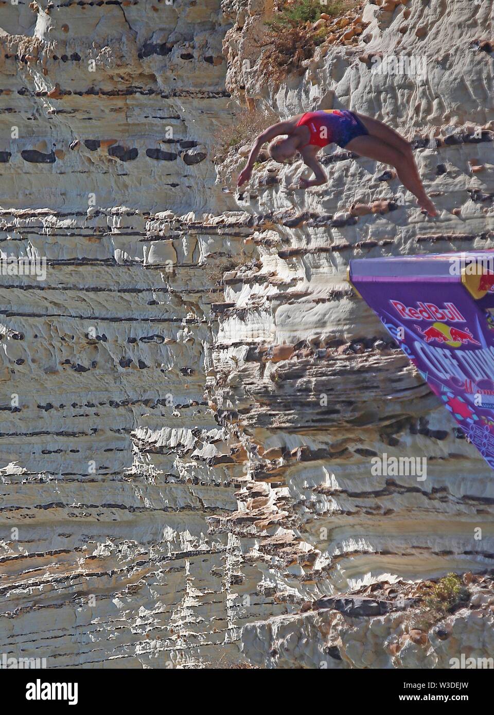 Beirut, Lebanon. 14th July, 2019. Rhiannan Iffland of Australia jumps from the landmark Rouche sea rock during the Red Bull Cliff Diving World Series in Beirut, Lebanon, July 14, 2019. Credit: Bilal Jawich/Xinhua/Alamy Live News Stock Photo