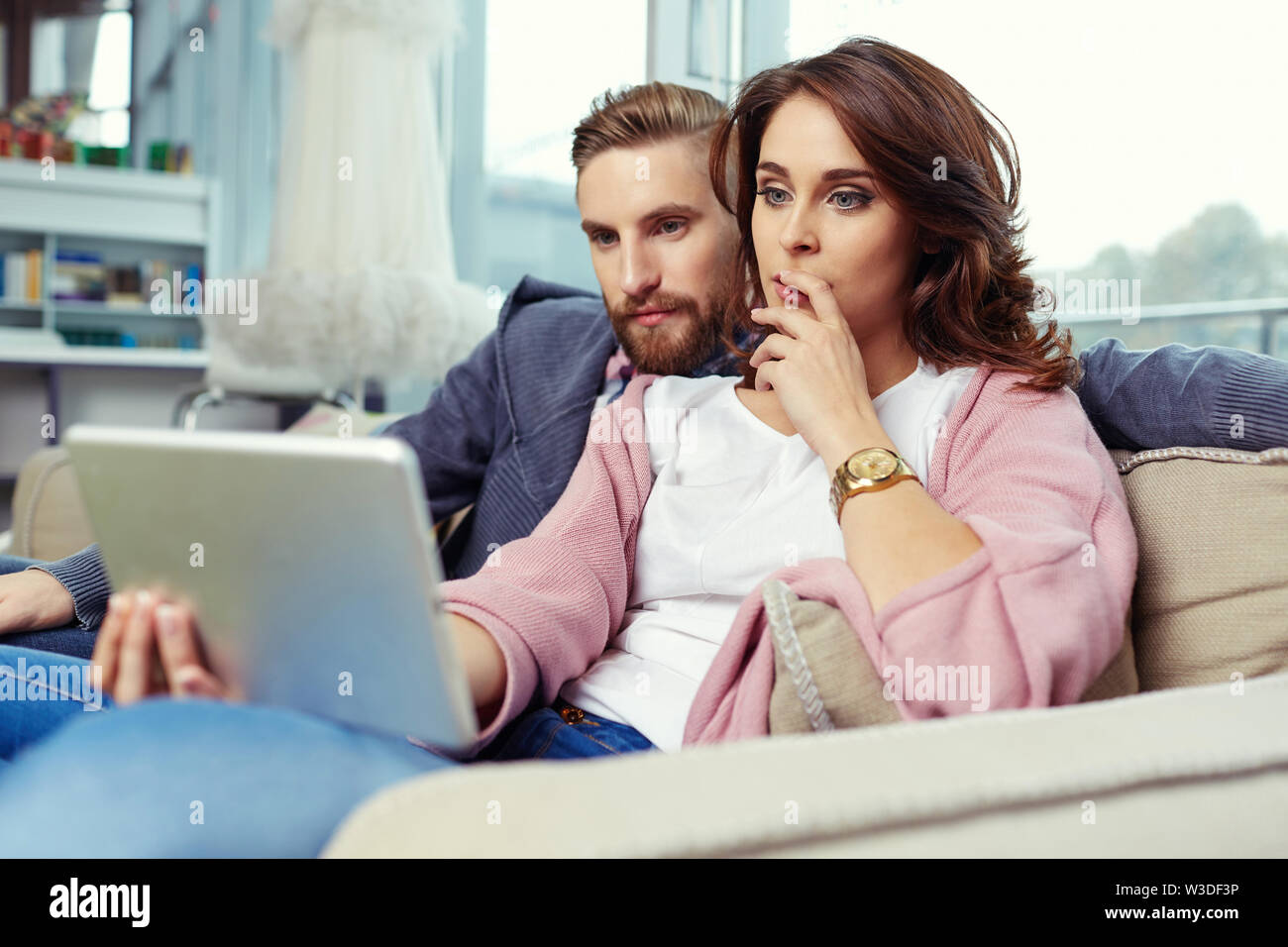 Young couple watching movie on digital tablet Stock Photo