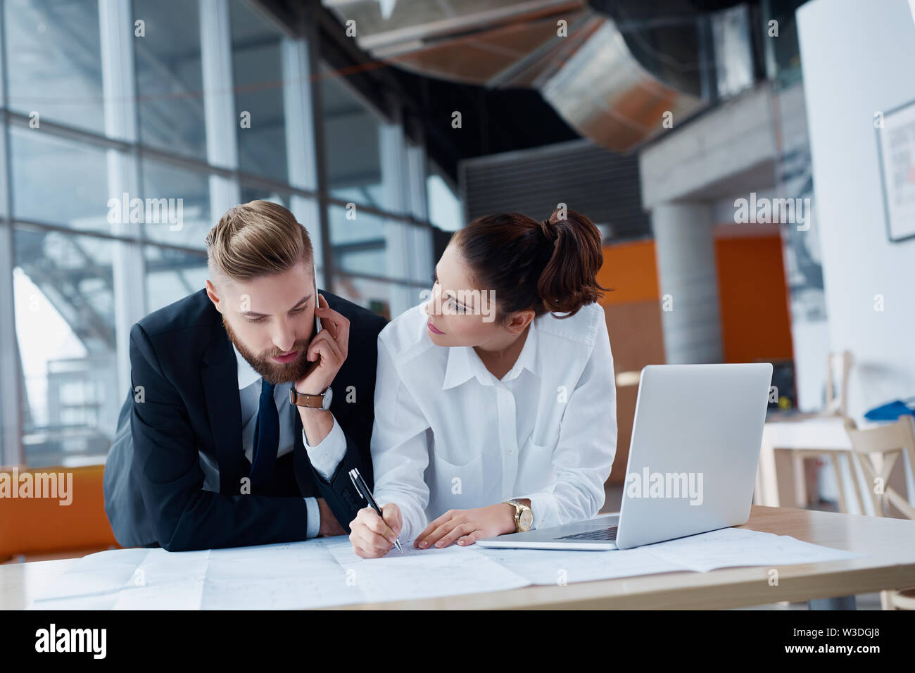 Two architects, business people working on plan at modern office Stock Photo