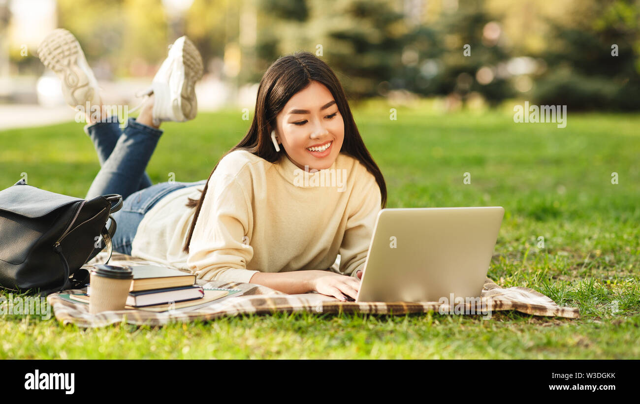 Happy student girl with laptop preparing for exams outdoors Stock Photo ...