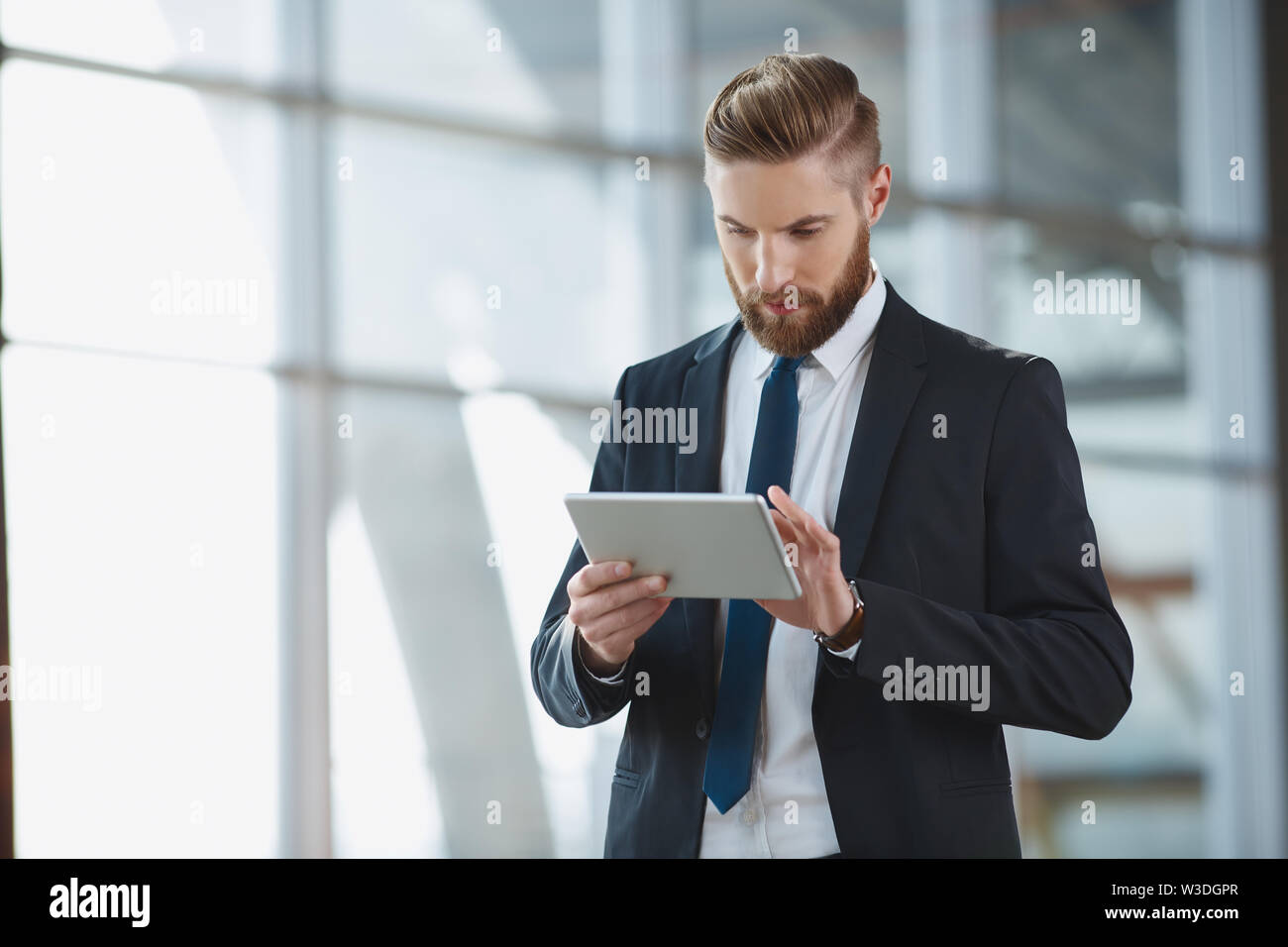 Modern hipster businessman with digital tablet at office Stock Photo