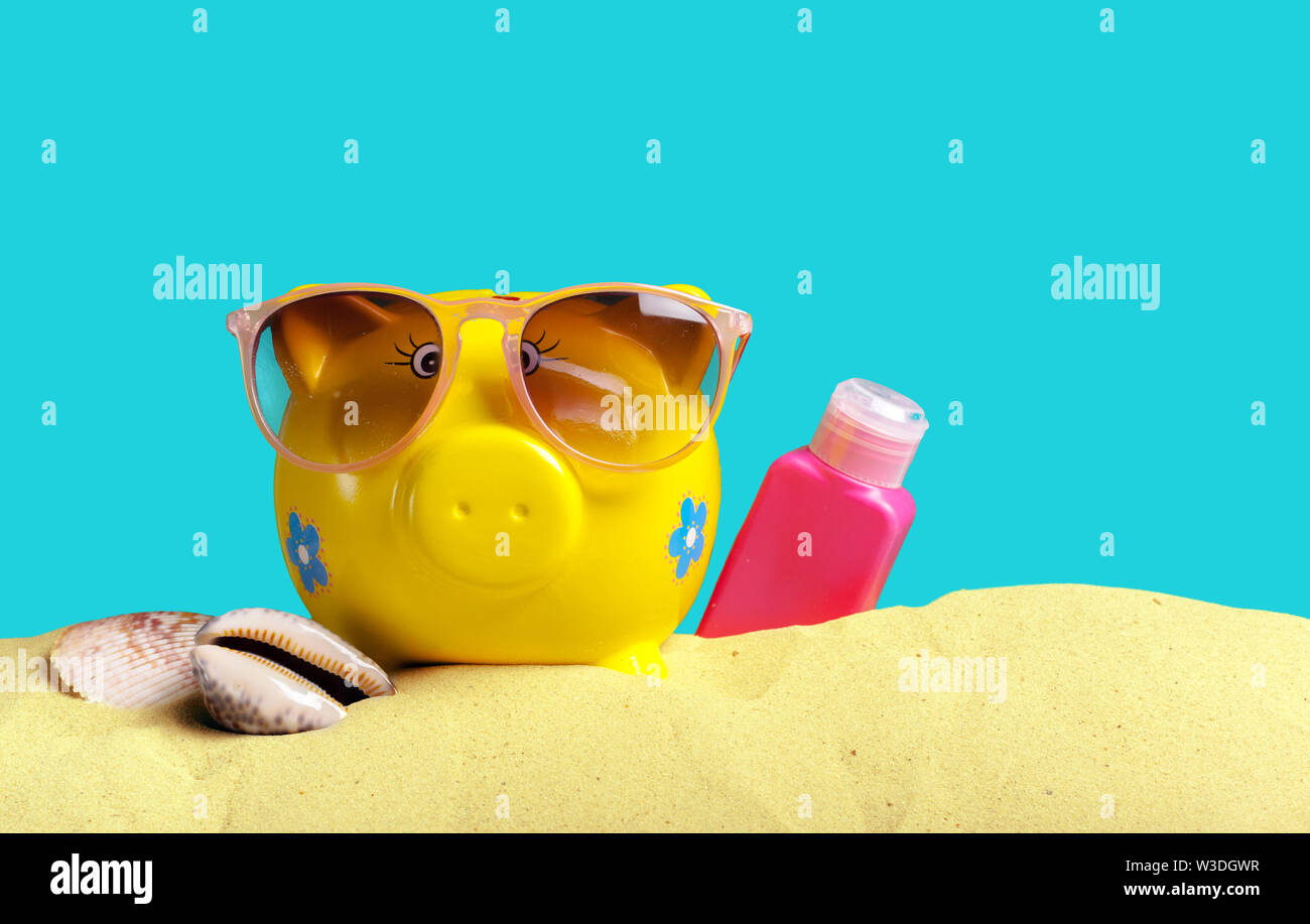Summer piggy bank with sunglasses on the beach Stock Photo - Alamy