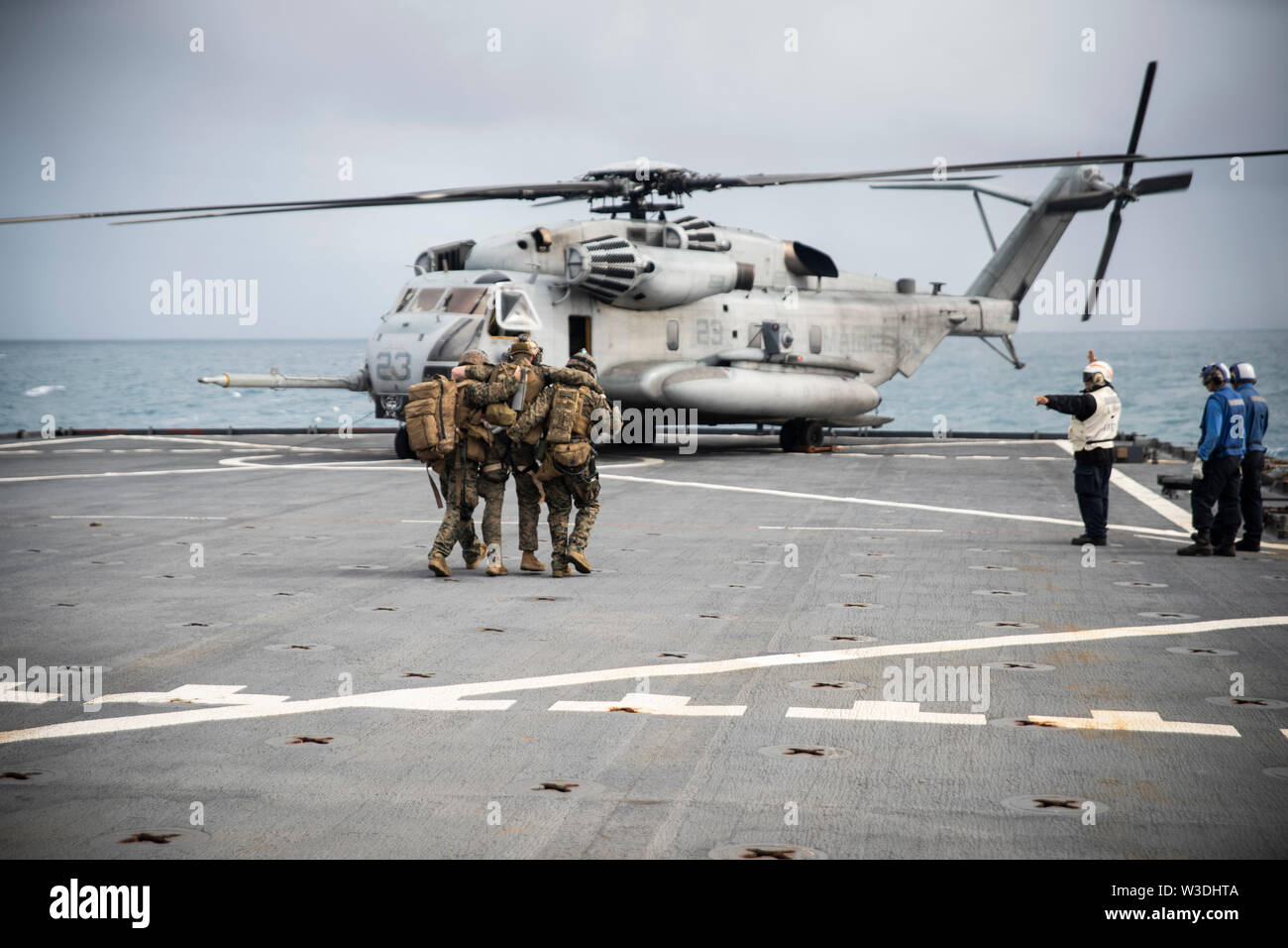 Force Reconnaissance Marines with the 31st Marine Expeditionary Unit Maritime Raid Force assist a simulated casualty to a CH-53E Super Stallion helicopter during a visit, board, search and seizure exercise aboard the dock landing ship USS Ashland (LSD 48), underway in the Coral Sea, July 7, 2019. Ashland, part of the Wasp Amphibious Ready Group, with embarked 31st MEU, is operating in the Indo-Pacific region to enhance interoperability with partners and serve as a ready-response force for any type of contingency, while simultaneously providing a flexible and lethal crisis response force ready Stock Photo