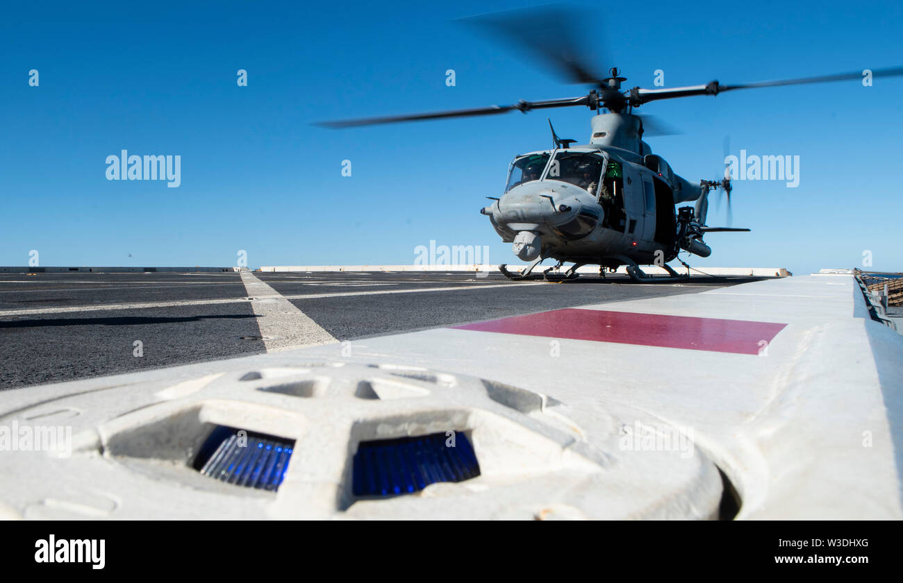 190712-N-DX072-1004 TASMAN SEA (July 12, 2019) A UH-1Y Huey helicopter, assigned to Marine Medium Tiltrotor Squadron (VMM) 265 (Reinforced), prepares for take off on the flight deck of the amphibious transport dock ship USS Green Bay (LPD 20). Green Bay, part of the Wasp Expeditionary Strike Group, with embarked 31st Marine Expeditionary Unit, is currently participating in Talisman Sabre 2019 off the coast of Northern Australia. A bilateral, biennial event, Talisman Sabre is designed to improve U.S. and Australian combat training, readiness and interoperability through realistic, relevant trai Stock Photo