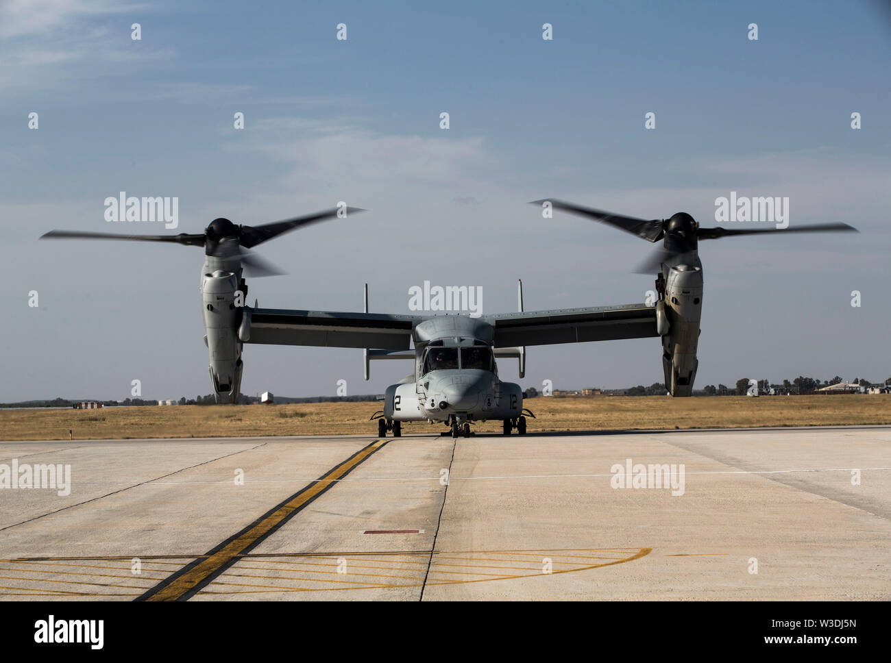 A U.S. Marine Corps MV-22B Osprey with Special Purpose Marine Air-Ground Task Force-Crisis Response-Africa 19.2, Marine Forces Europe and Africa, prepares to conduct an external lift during helicopter support team training on Moron Air Base, Spain, July 9, 2019. The exercise was conducted to increase interoperability between the aviation combat element and logistics combat element. SPMAGTF-CR-AF is deployed to conduct crisis-response and theater-security operations in Africa and promote regional stability by conducting military-to-military training exercises throughout Europe and Africa. (U.S. Stock Photo