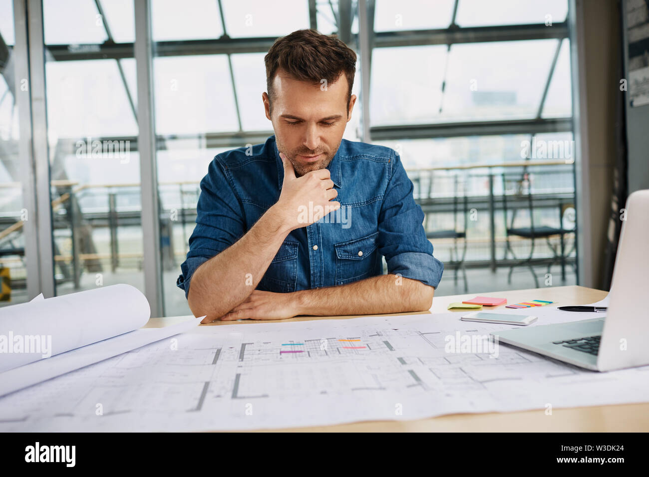 Thoughtful male architect working at office Stock Photo