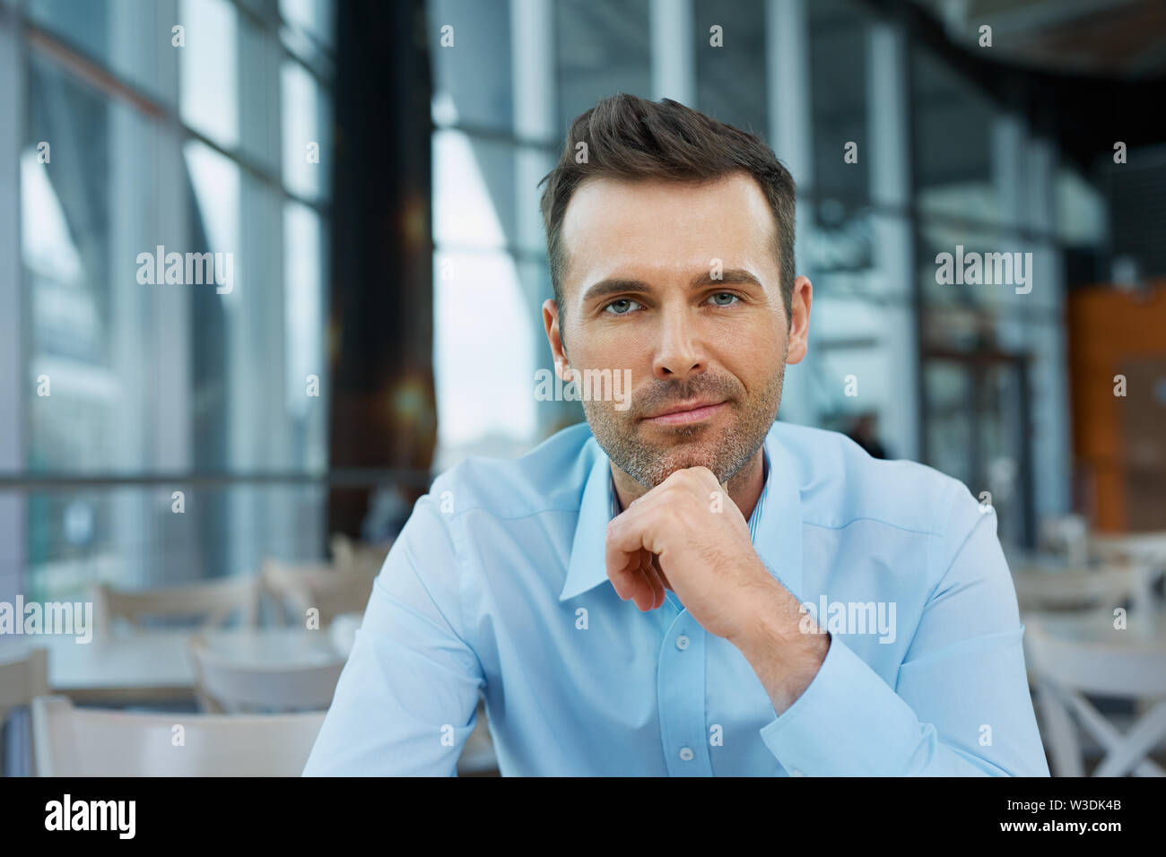 Confident businessman at modern office looking at camera Stock Photo ...