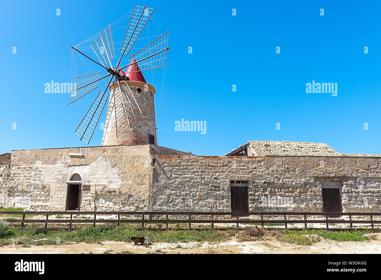 Windmill at the salt flats of Trapani, Sicily, Italy Stock Photo