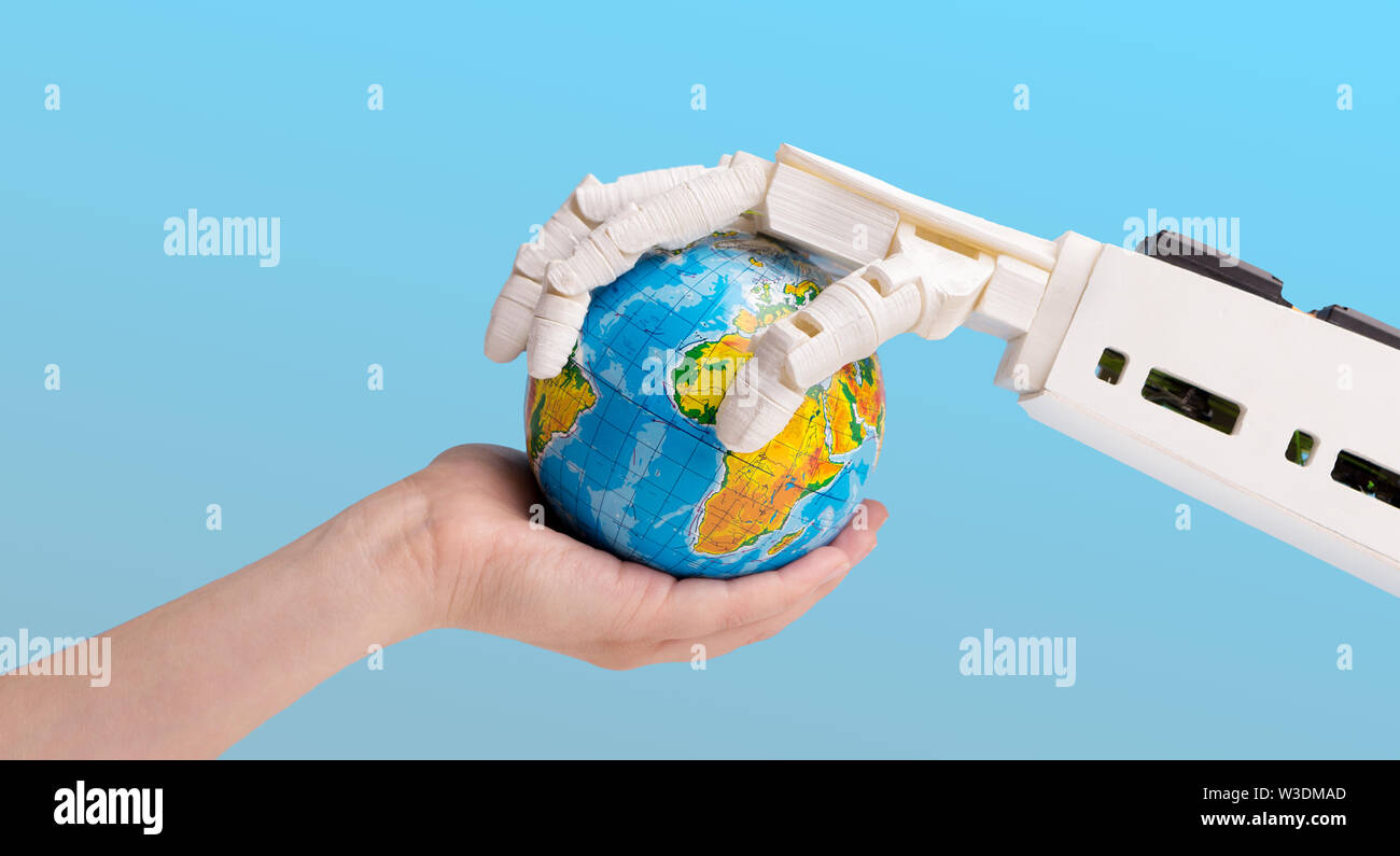 Human and robot hands holding earth globe Stock Photo