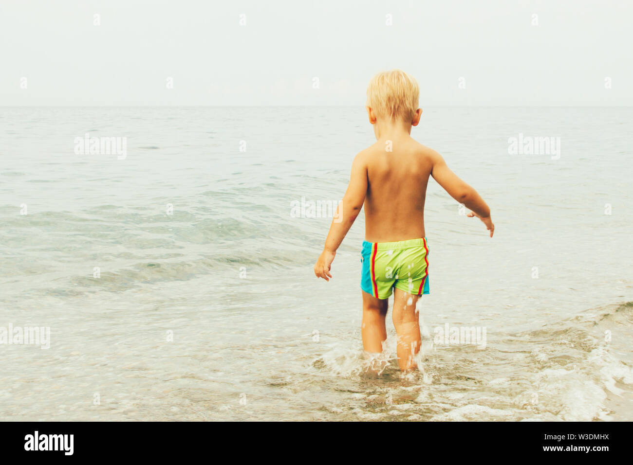 little boy in swim trunks