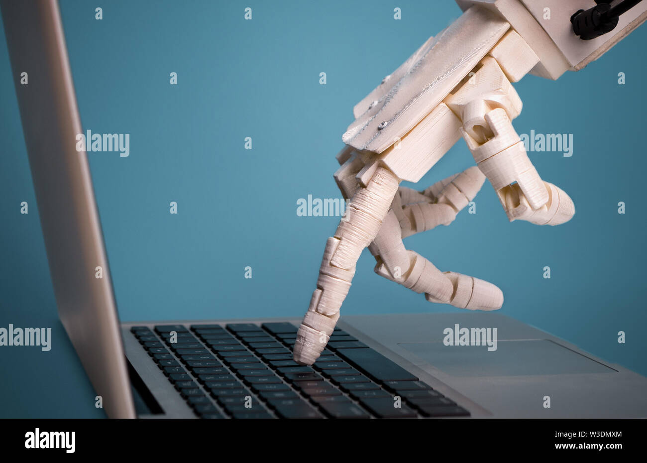 Robot finger point to laptop button, free space Stock Photo