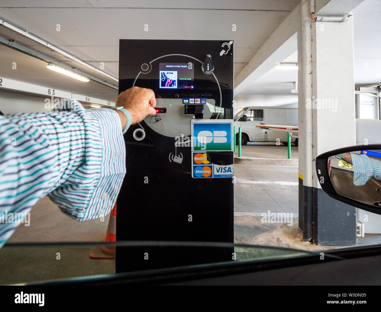 Basel, Switzerland - Jun 5, 2018: man hand inserting ticket in side the  barrier ticket machine to exit French parking lot Stock Photo - Alamy