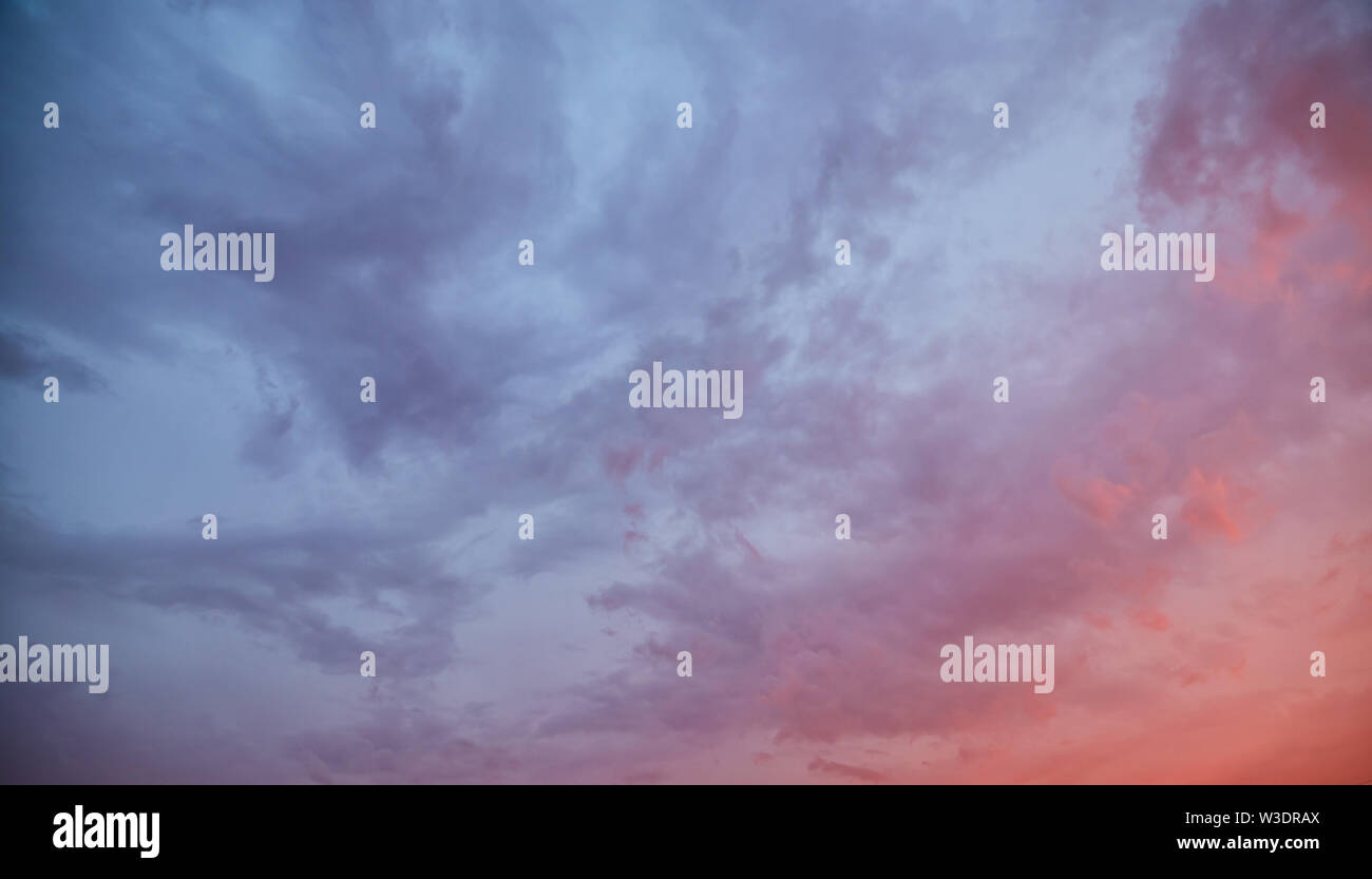 Dramatic sky at sunset with clouds lit by the setting sun Stock Photo