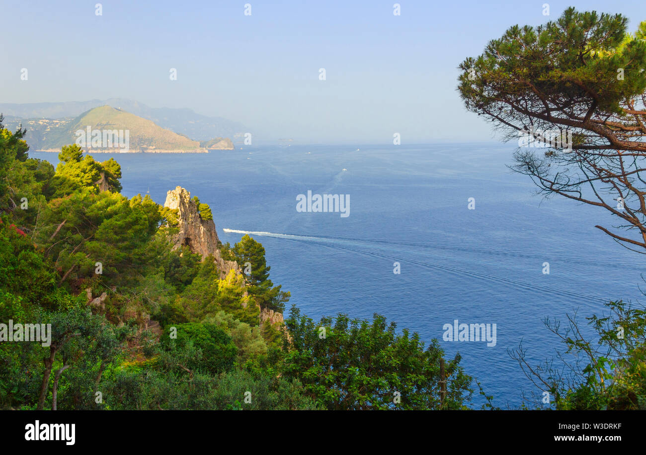 Capri Island. Magnificent view from the sea on the rocky shores of the island of Capri and the mountains surrounding the Amalfi coast. Stock Photo