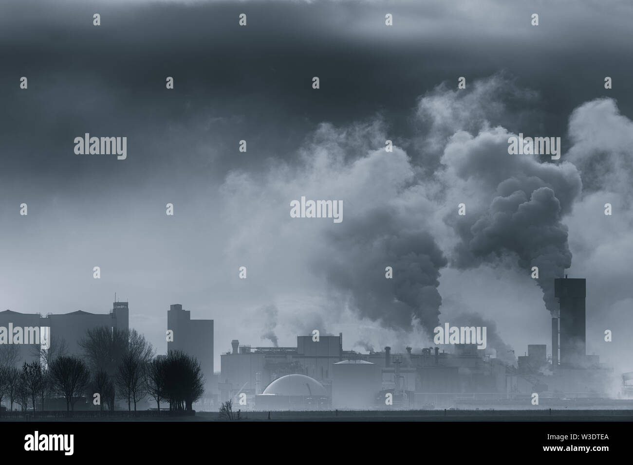 A chemical plant polluting the air and causing rising temperatures and global warming - The Netherlands Stock Photo