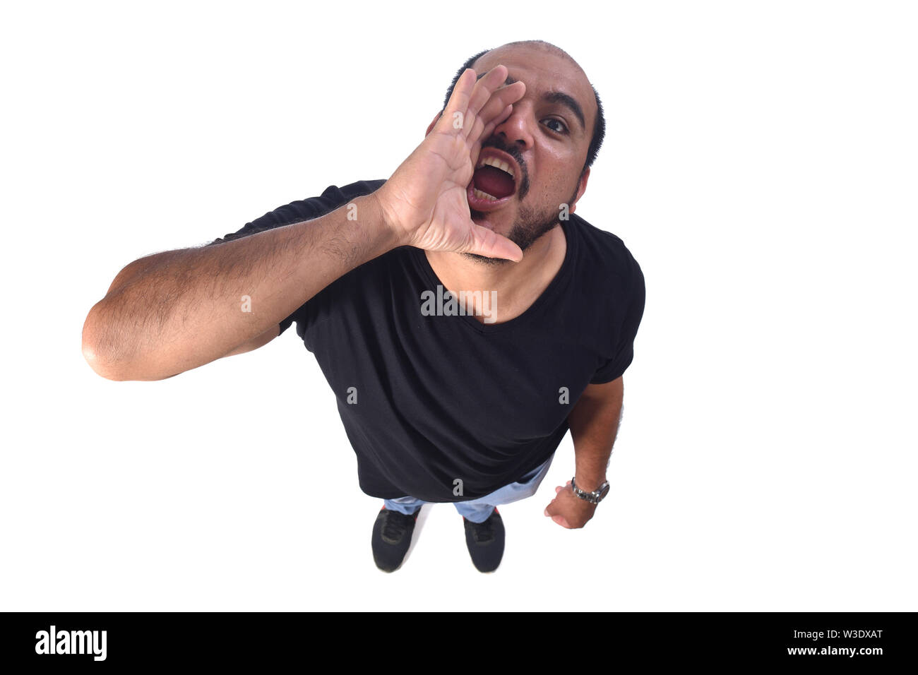 latin american man putting a hand in mouth and is screaming on white  background Stock Photo - Alamy