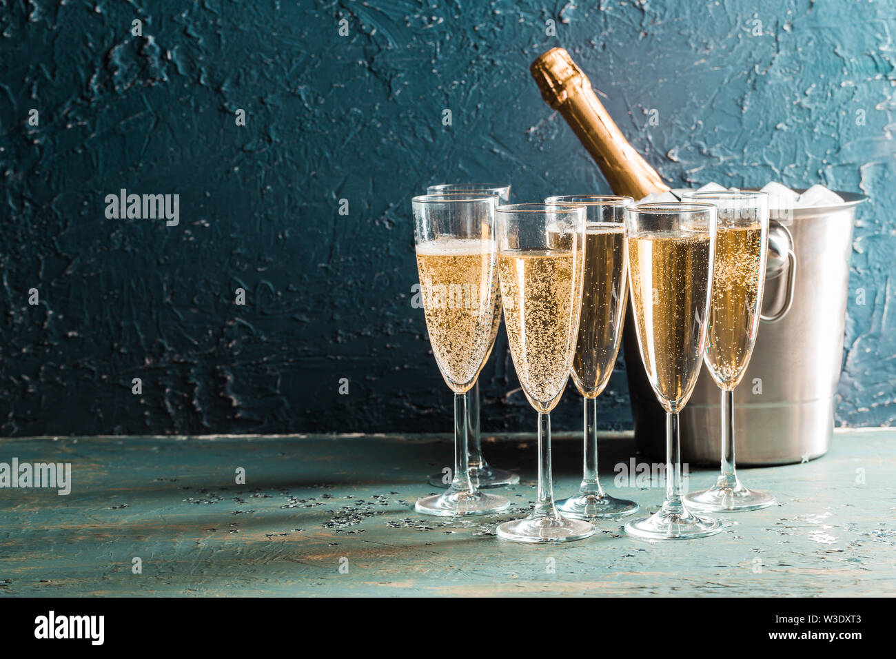 Champagne bottle in an ice bucket icon in cartoon,black desgn isolated on w...