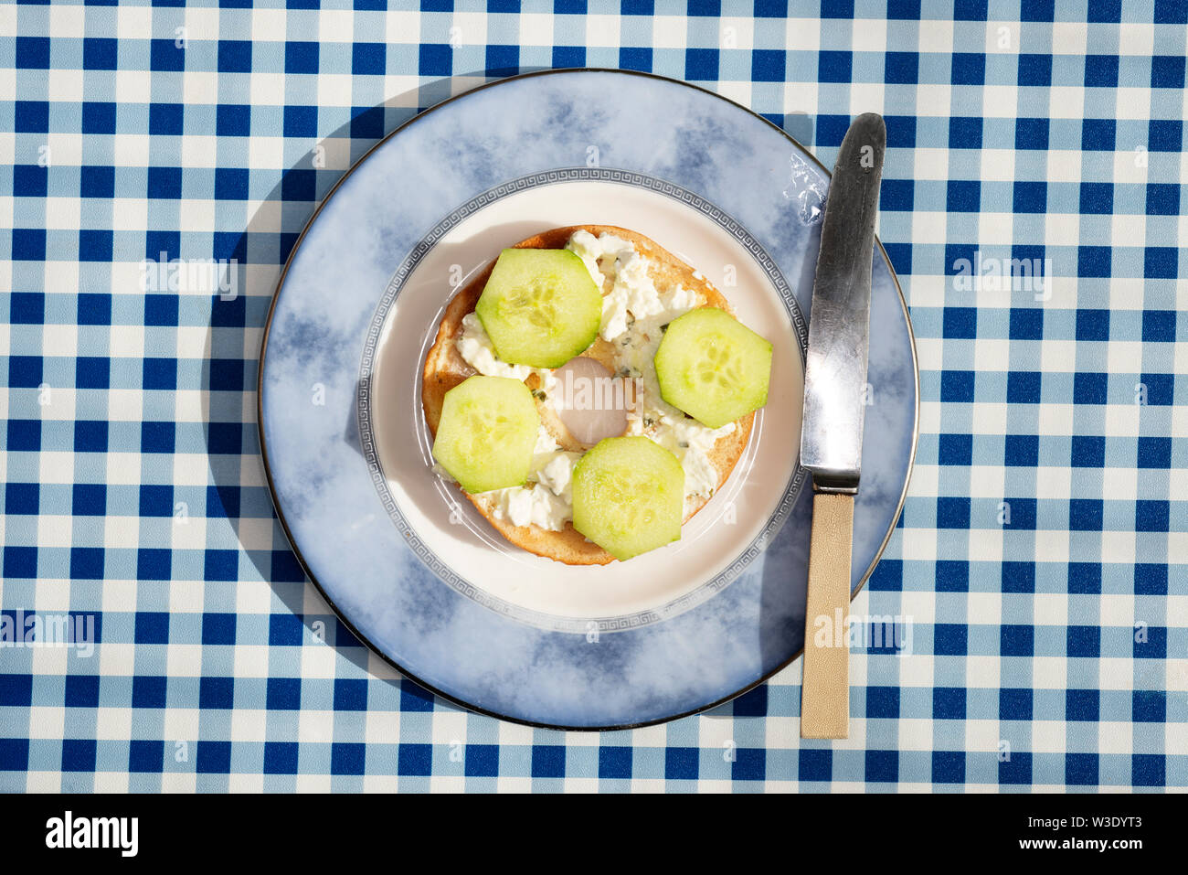 Cottage cheese and sliced cucumber on toasted bagel Stock Photo