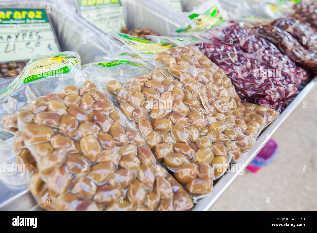 Selection of packed Greek olives ready for sale on street food market in Greece. Healthy food