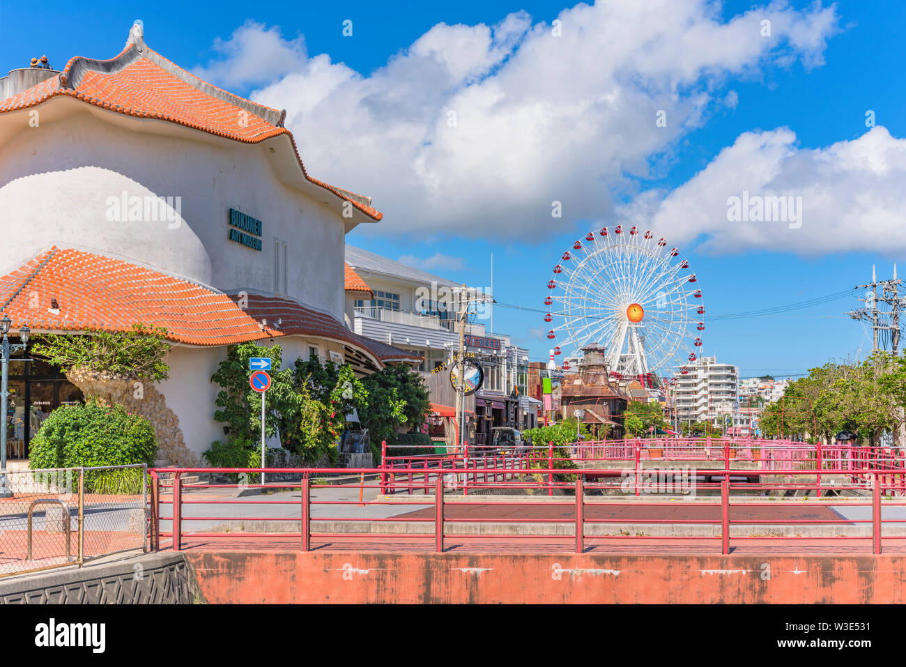 Chatan City red steel bridge and Mihama Carnival Park Ferris wheel in the American Village Stock Photo