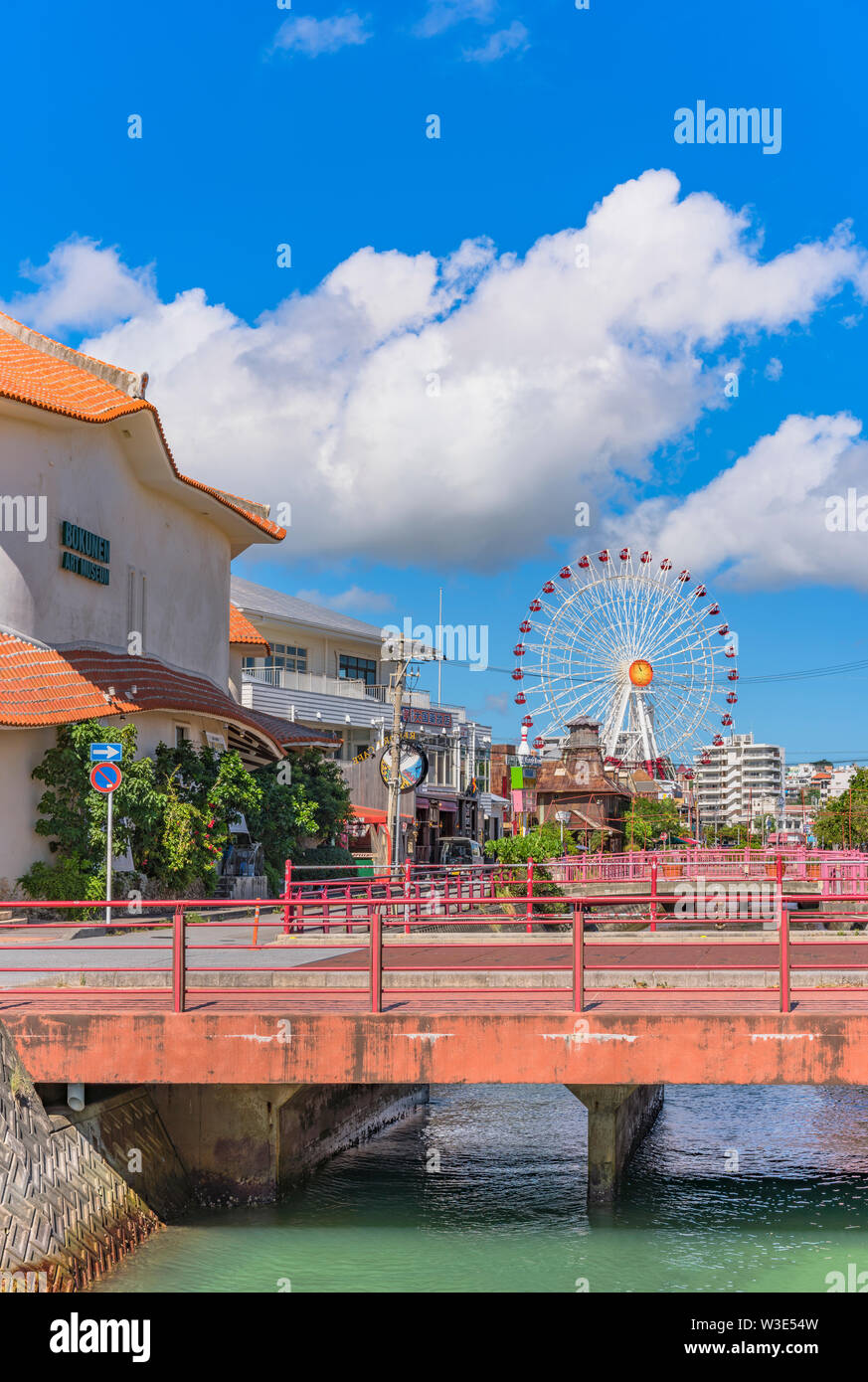 Chatan City red steel bridge and Mihama Carnival Park Ferris wheel in the American Village Stock Photo