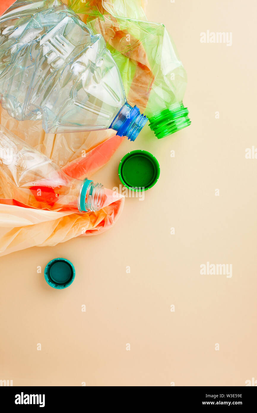Used empty plastic water bottles crushed and crumpled in garbage bag for sorting (segregating