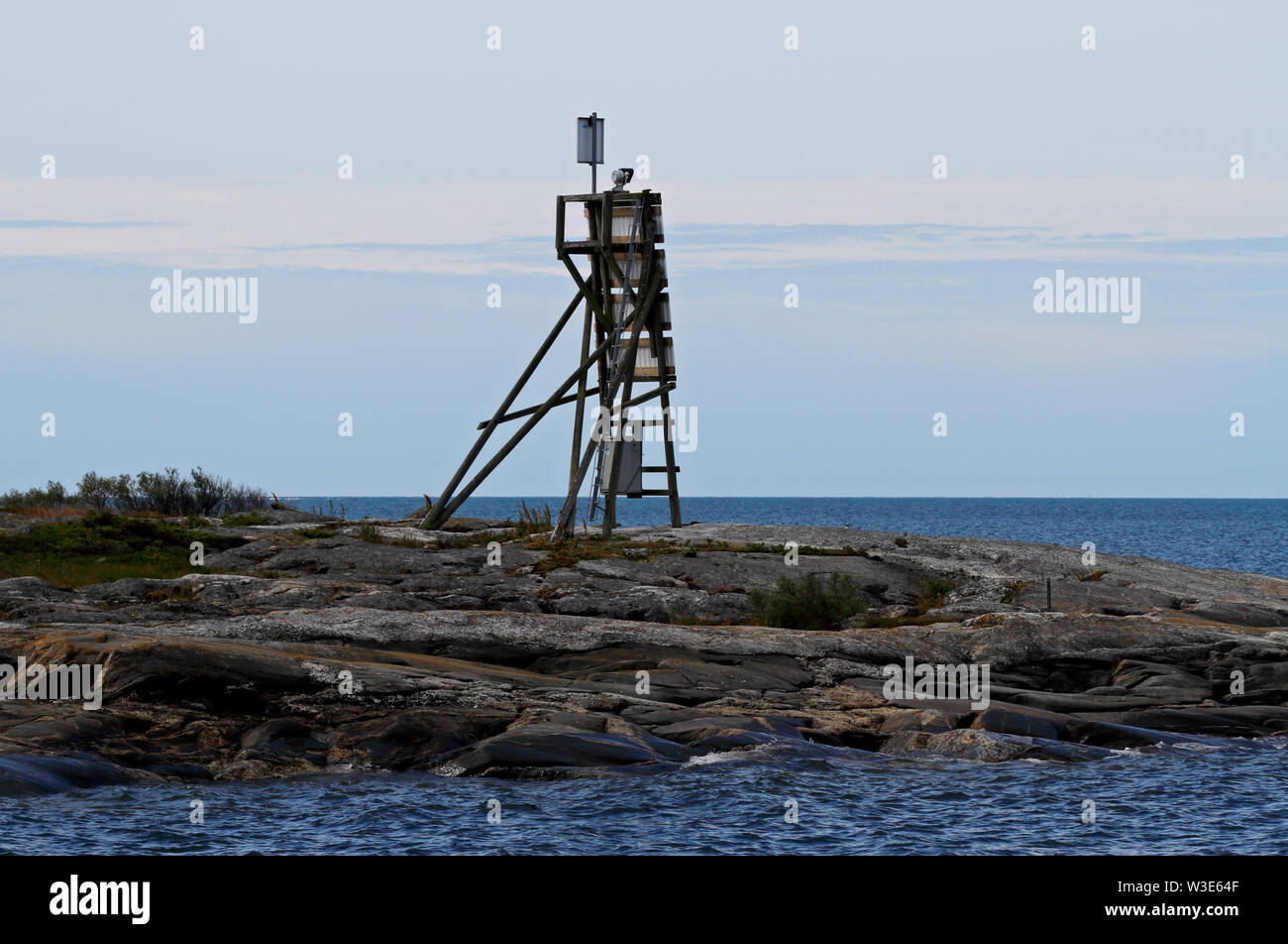 A  sea mark standing on a cliff on the islet of the Bothnian sea Stock Photo