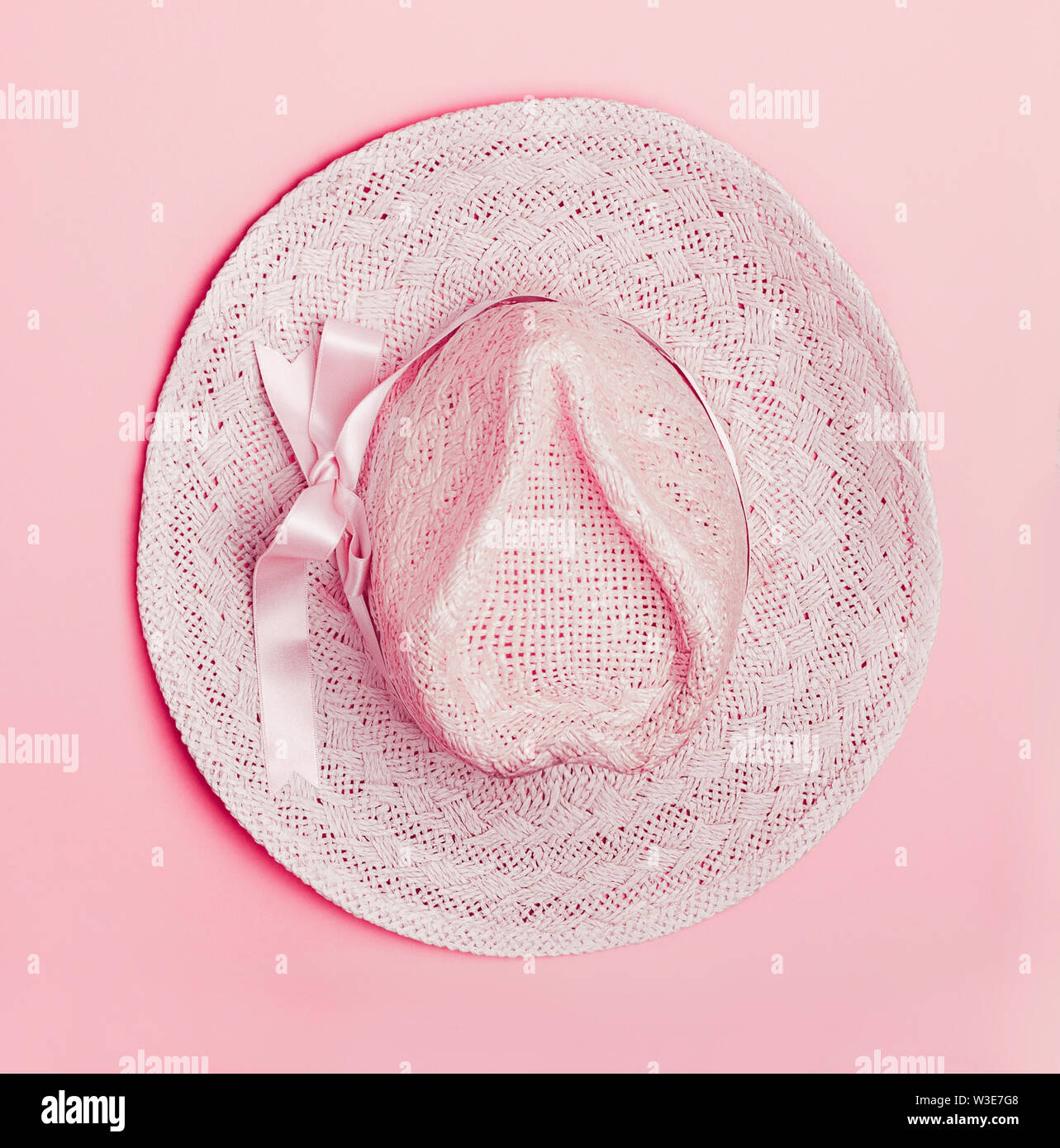 Sun hat on pastel pink background, top view. Summer concept Stock Photo