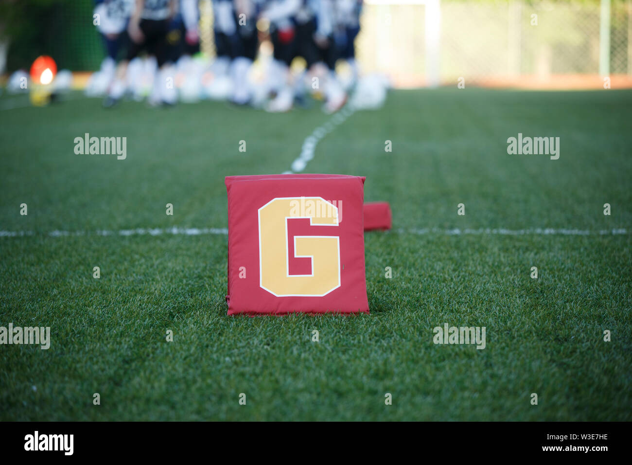 Photo of green field for American football with letter g on blurred ...