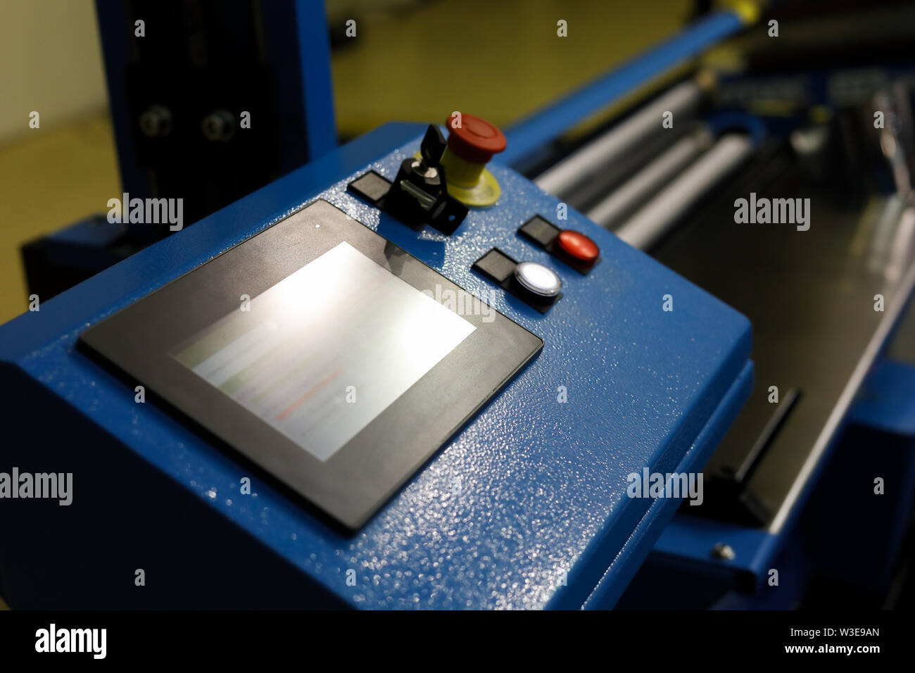 Computer controlled metal sheet bending machine. Selective focus. Stock Photo