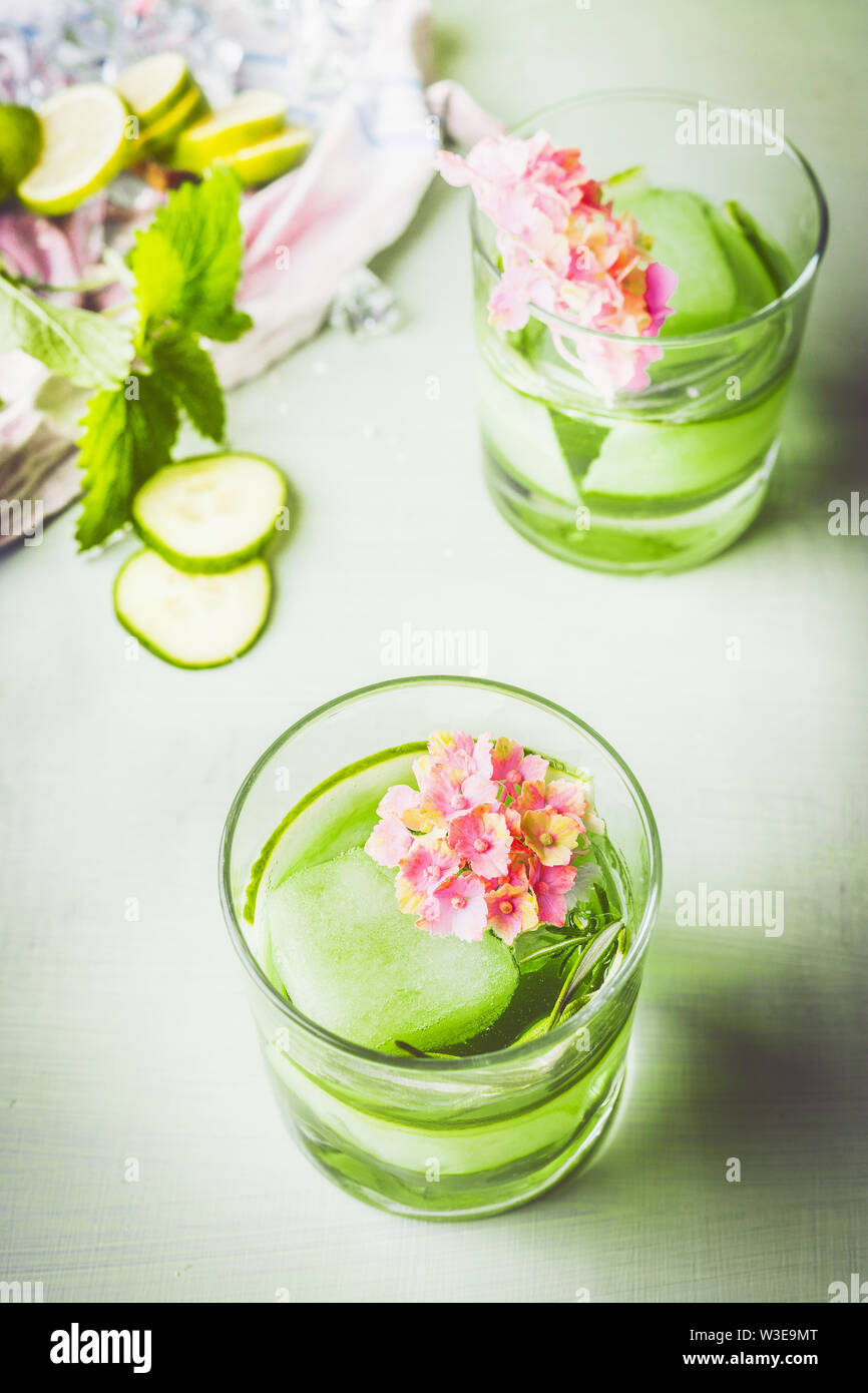 Glass of green iced cucumber rosemary drink. refreshing drink with ice. Infused water . Healthy summer beverages . Homemade lemonade with fresh herbs Stock Photo
