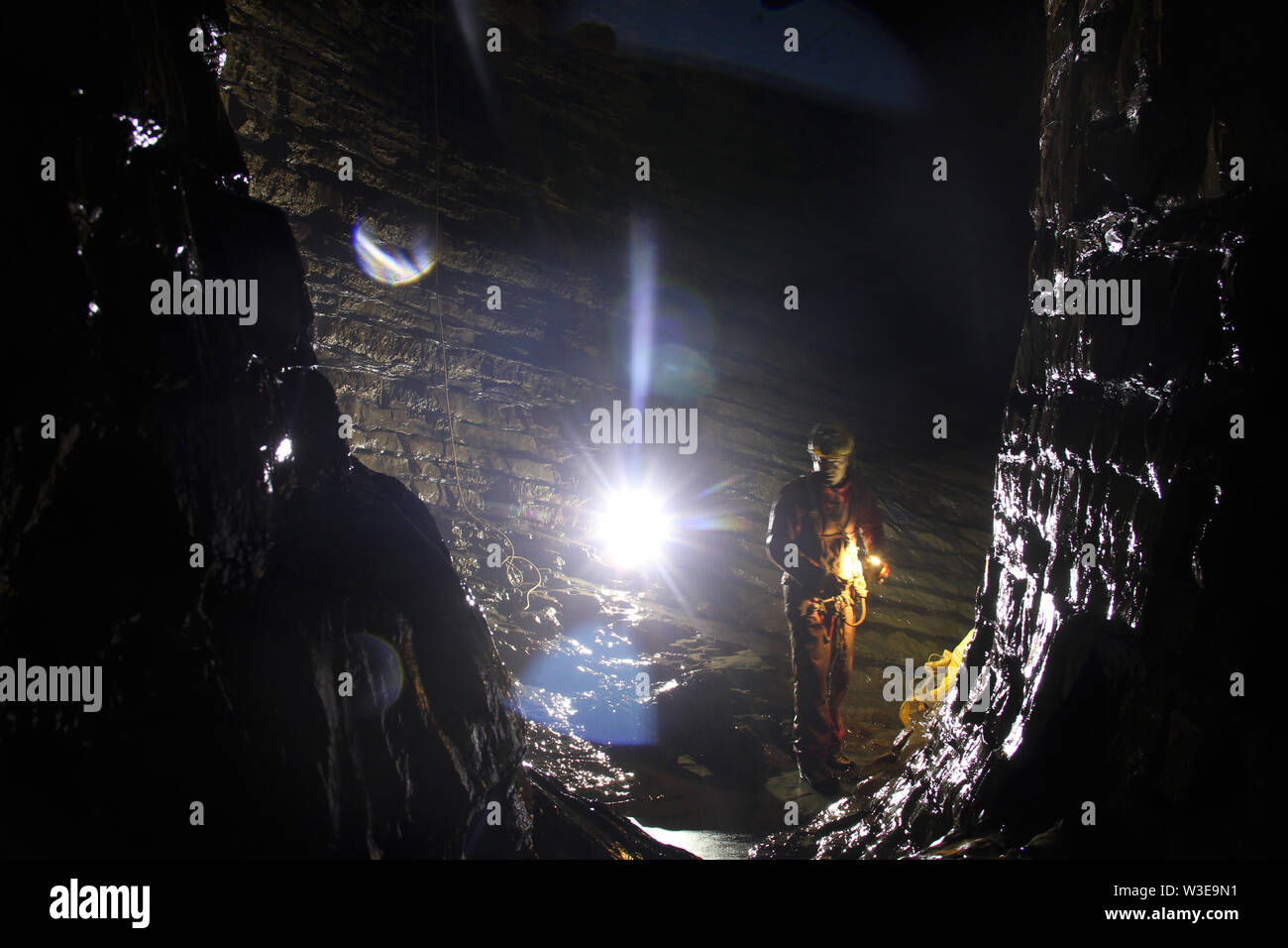 Caver exploring a cave Stock Photo - Alamy