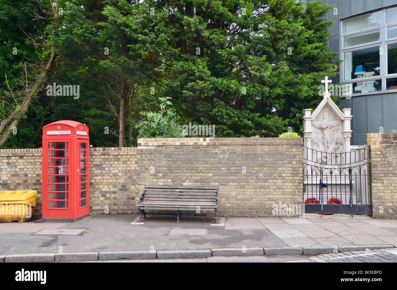 iconic red telephone box kiosk in london with samaritan hotline near archway suicide bridge north london Stock Photo