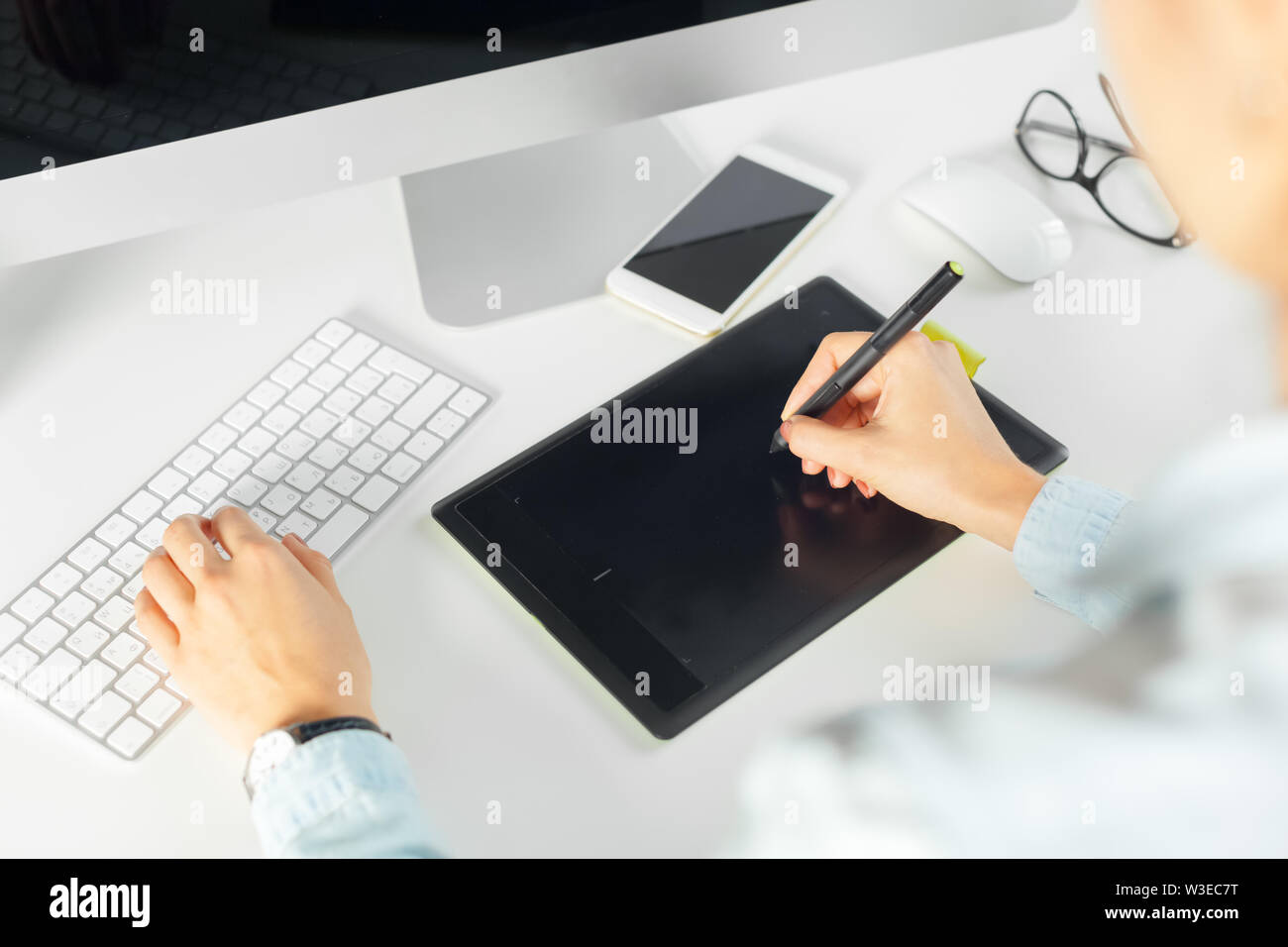 Young female designer using graphics tablet Stock Photo