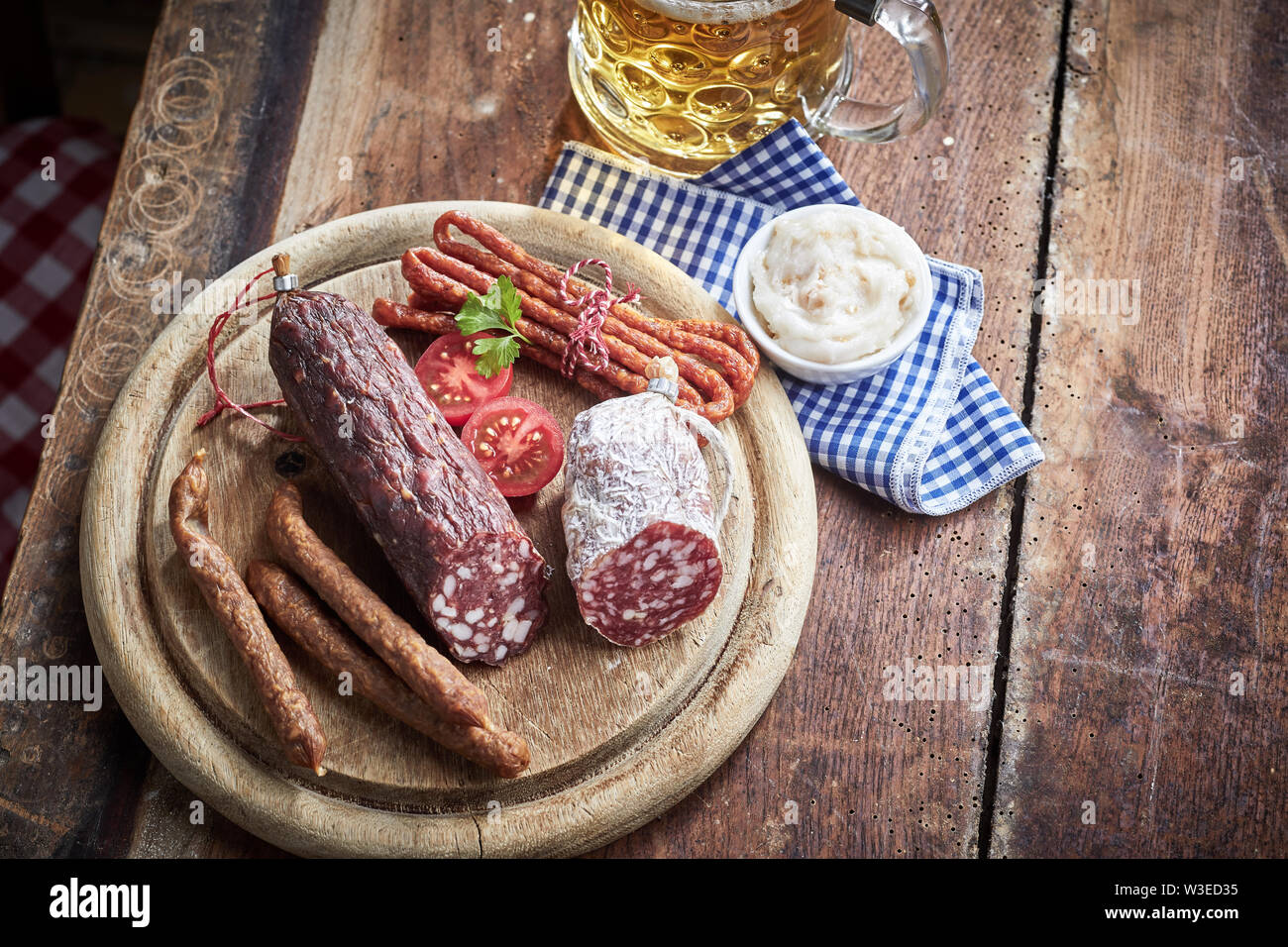 Selection of spicy cured wild venison sausages on an old board served