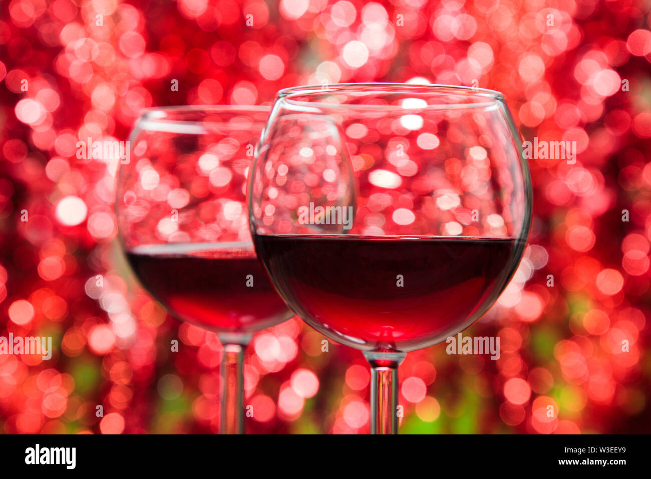 https://c8.alamy.com/comp/W3EEY9/two-glasses-of-red-wine-against-defocused-holiday-lights-background-W3EEY9.jpg