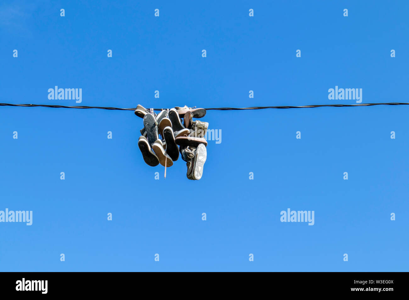 shoes hanging from a electric wire Stock Photo Alamy