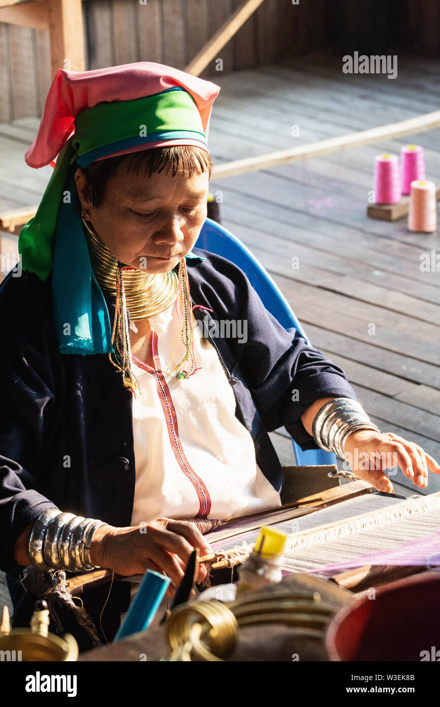 Inle, Myanmar - March 2019: Kayan Lahwi tribe long neck woman sits behind the loom in a tourist shop on Inle lake Stock Photo