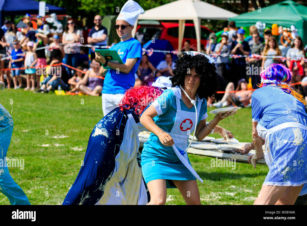 World Custard Pie Championship. Young women team dressed as nurses with