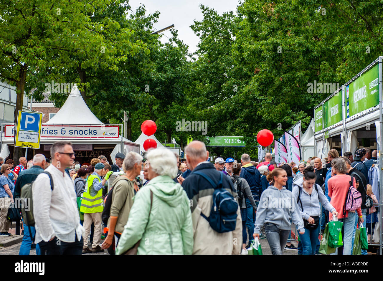Participants buy official products before the walking event.The International Four Days Marches, called 'Vierdaagse' in Nijmegen has grown into the largest multi-day walking event in the world. The day before, all the walkers go to pick their wristband with the number of registration at the start of the walk. Stock Photo