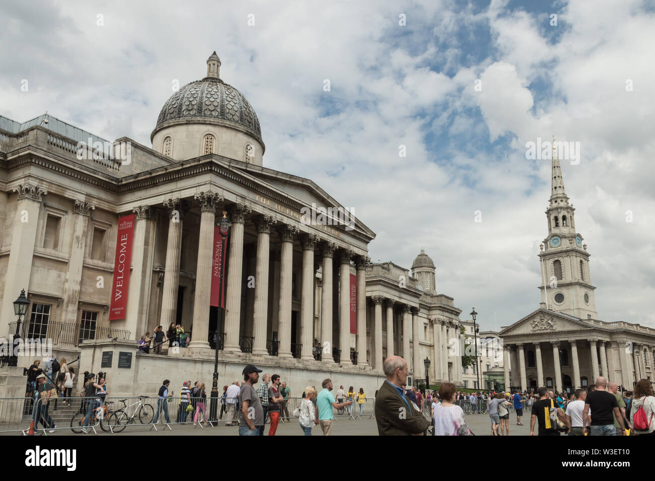 Facade of the National Gallery art museum crowded with tourists on a cloudy day.  Building is located in Trafalgar Square Stock Photo