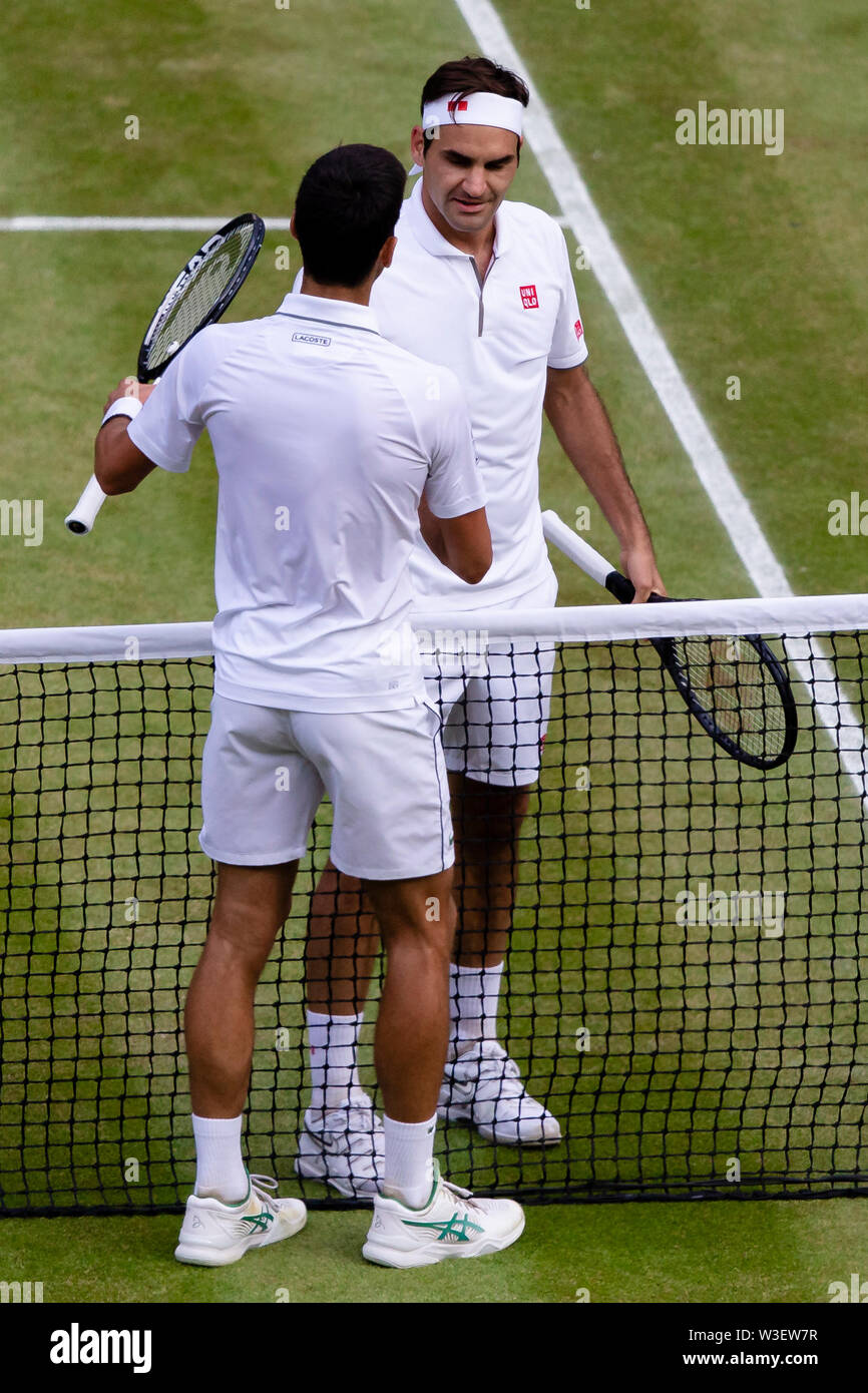 London, UK. 14th July, 2019. Tennis: Grand Slam/ATP Tour, Wimbledon,  Individual, Men, Final, Djokovic (Serbia) - Federer (Switzerland). Roger  Federer (r) and Novak Djokovic shake hands after the match. Credit: Frank  Molter/dpa/Alamy