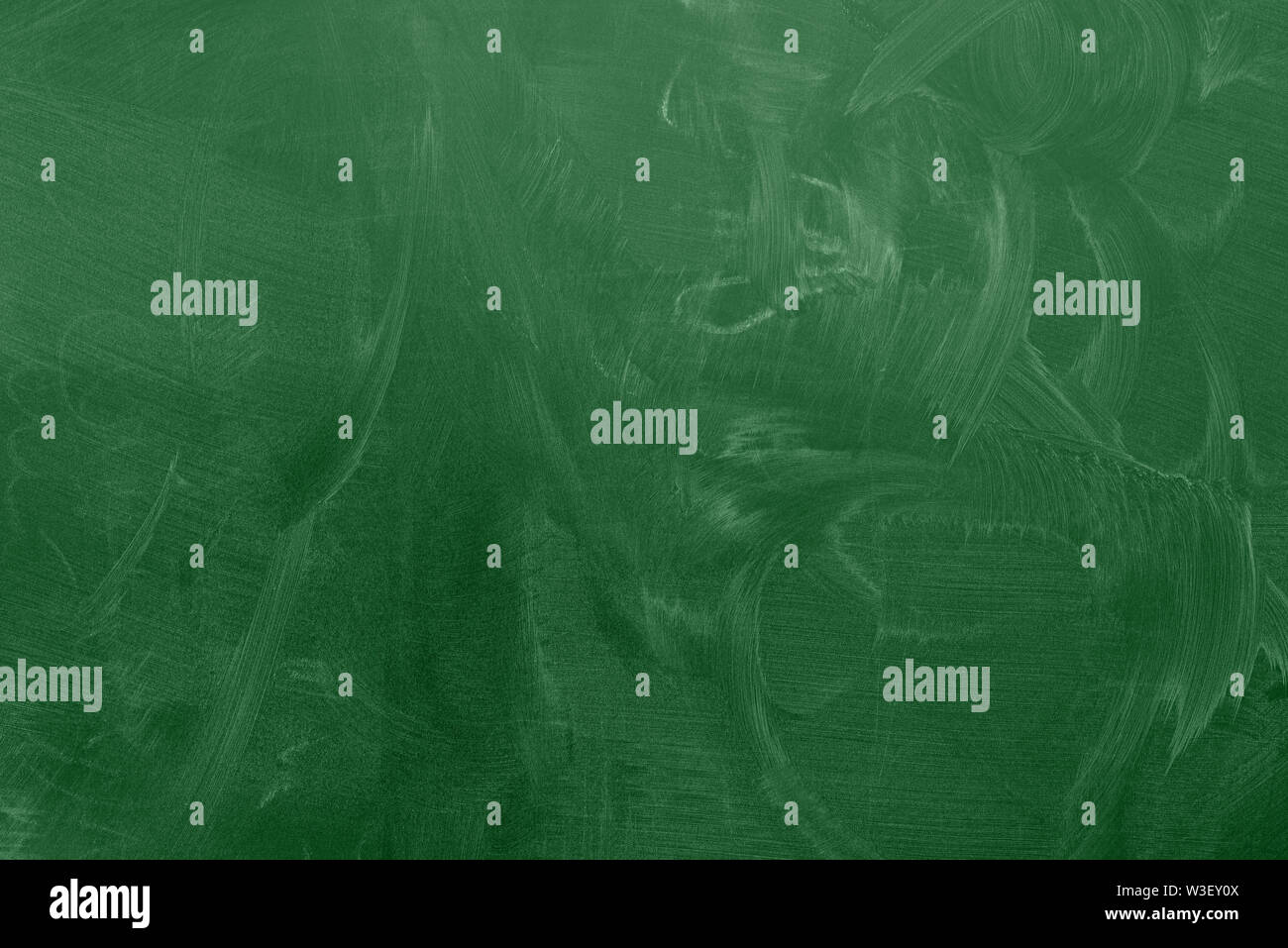 green classroom chalkboard or blackboard with chalk stains background Stock Photo
